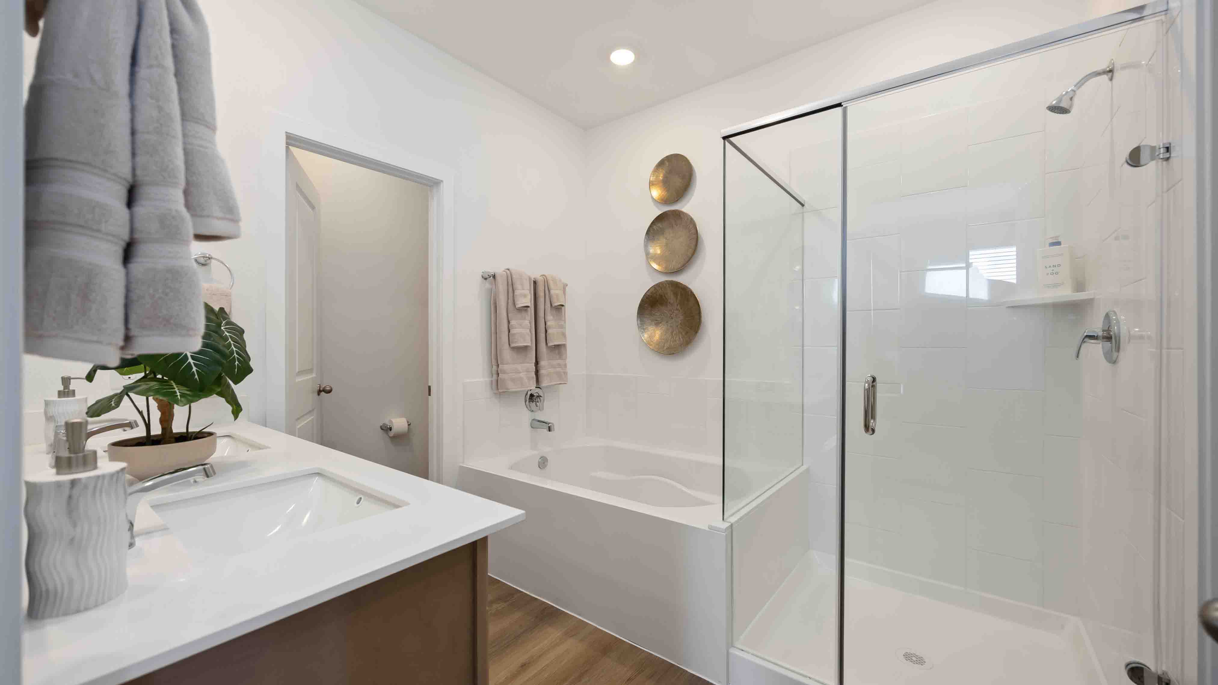 the en-suite primary bathroom has a double vanity and spacious walk-in closet