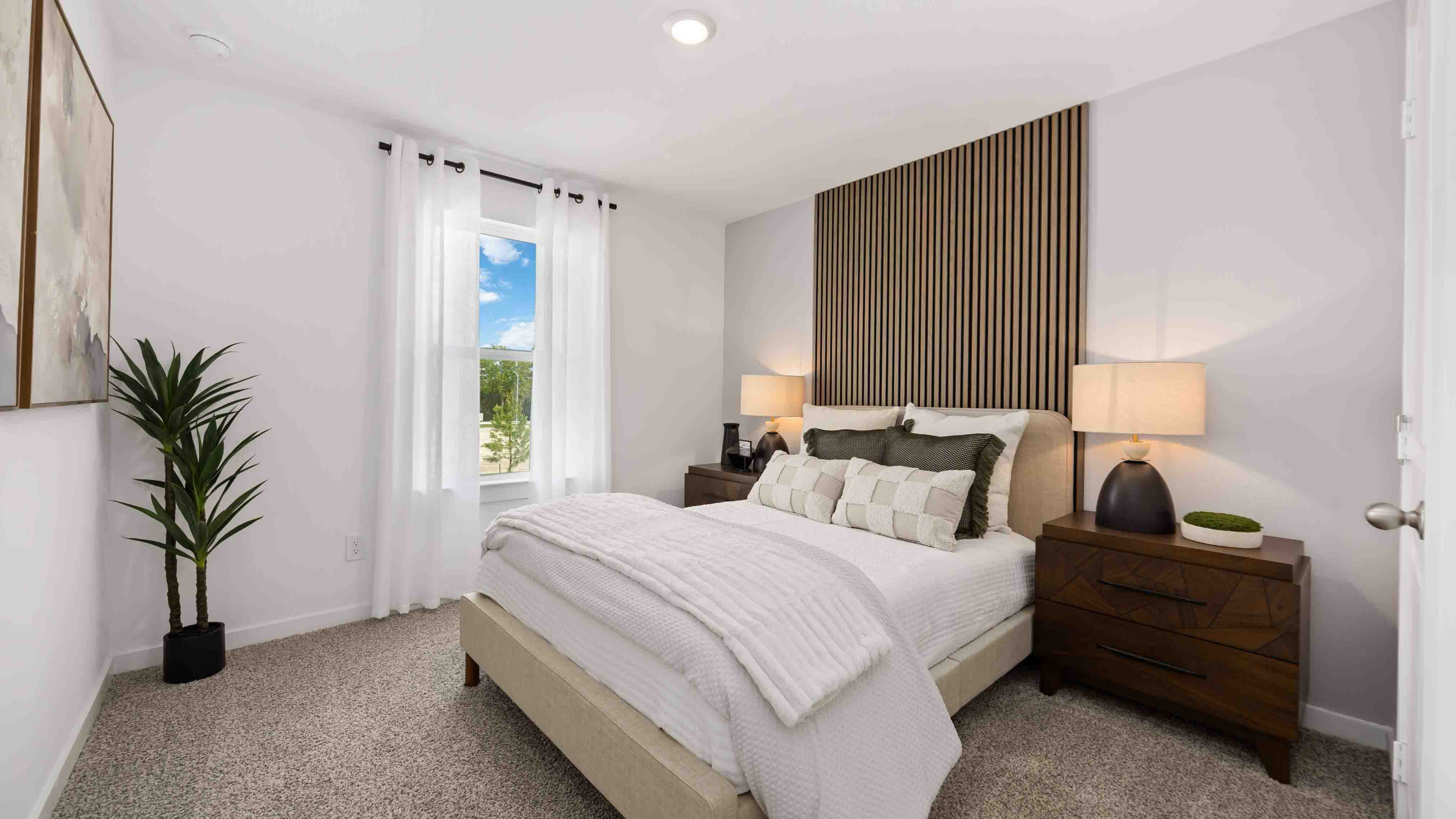 secondary bedrooms have light neutral walls and carpet flooring