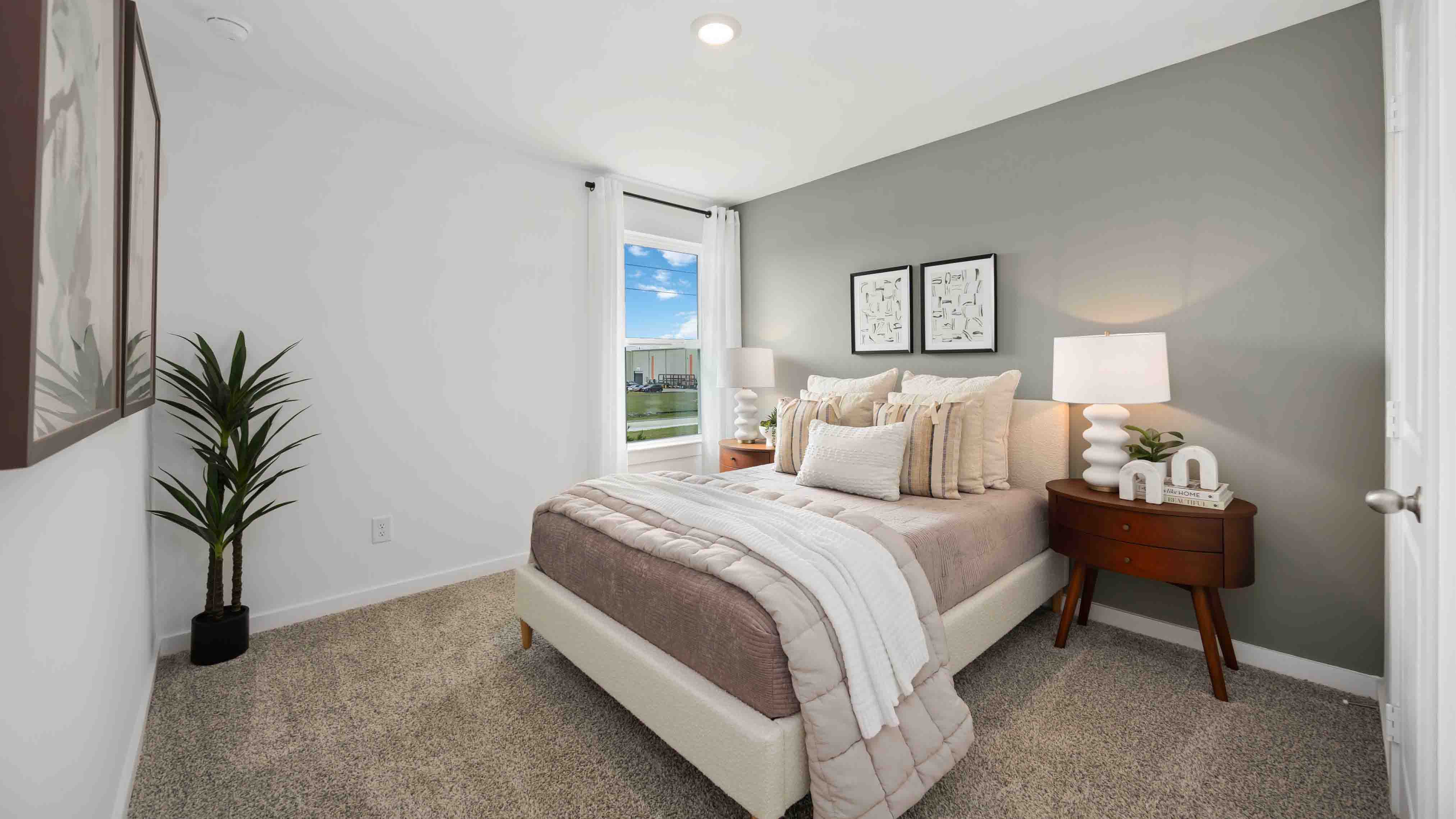 third bedroom has light neutral walls and carpet flooring