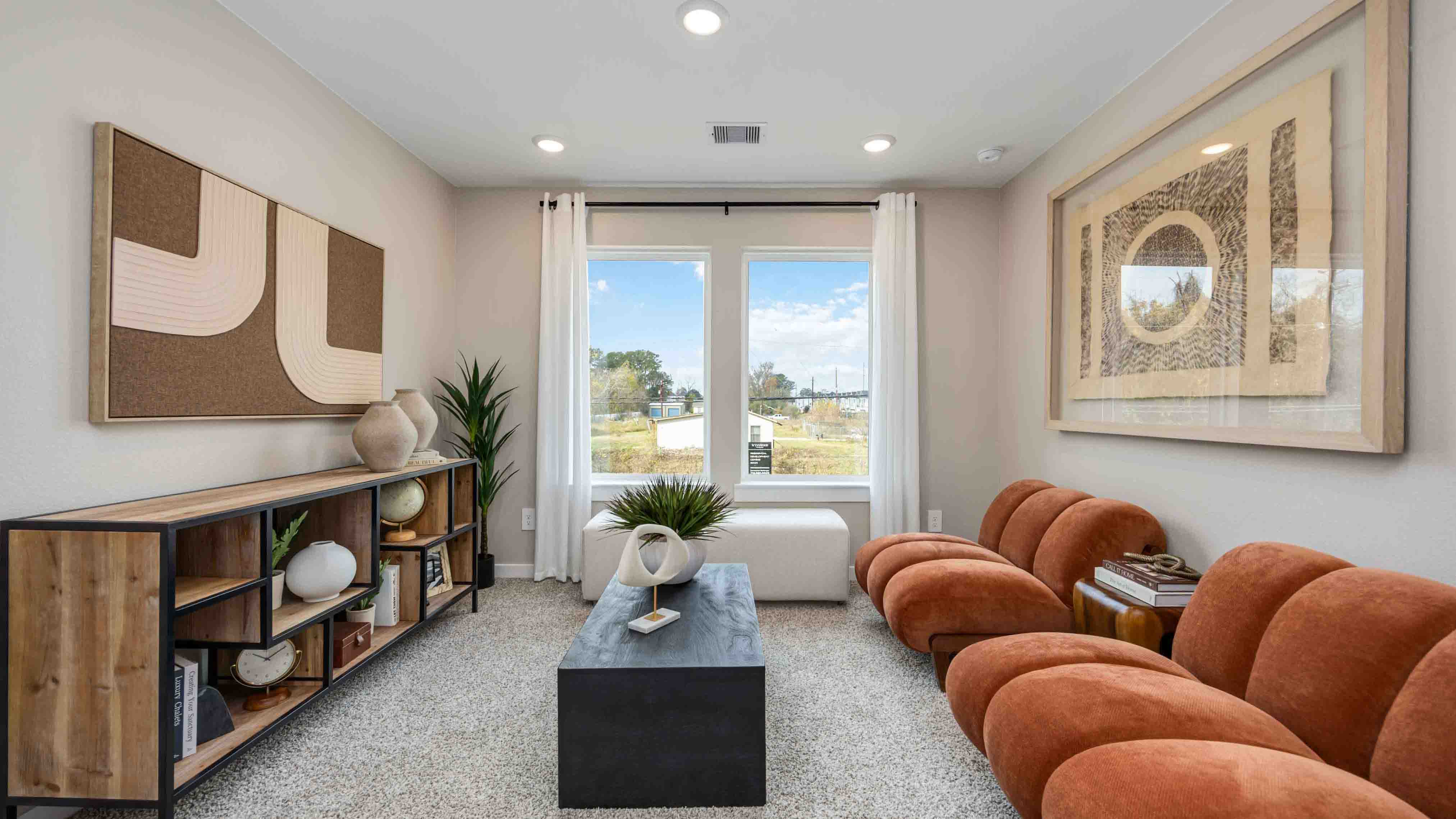 spacious upstairs living area with plenty of natural light from windows overlooking side of the home