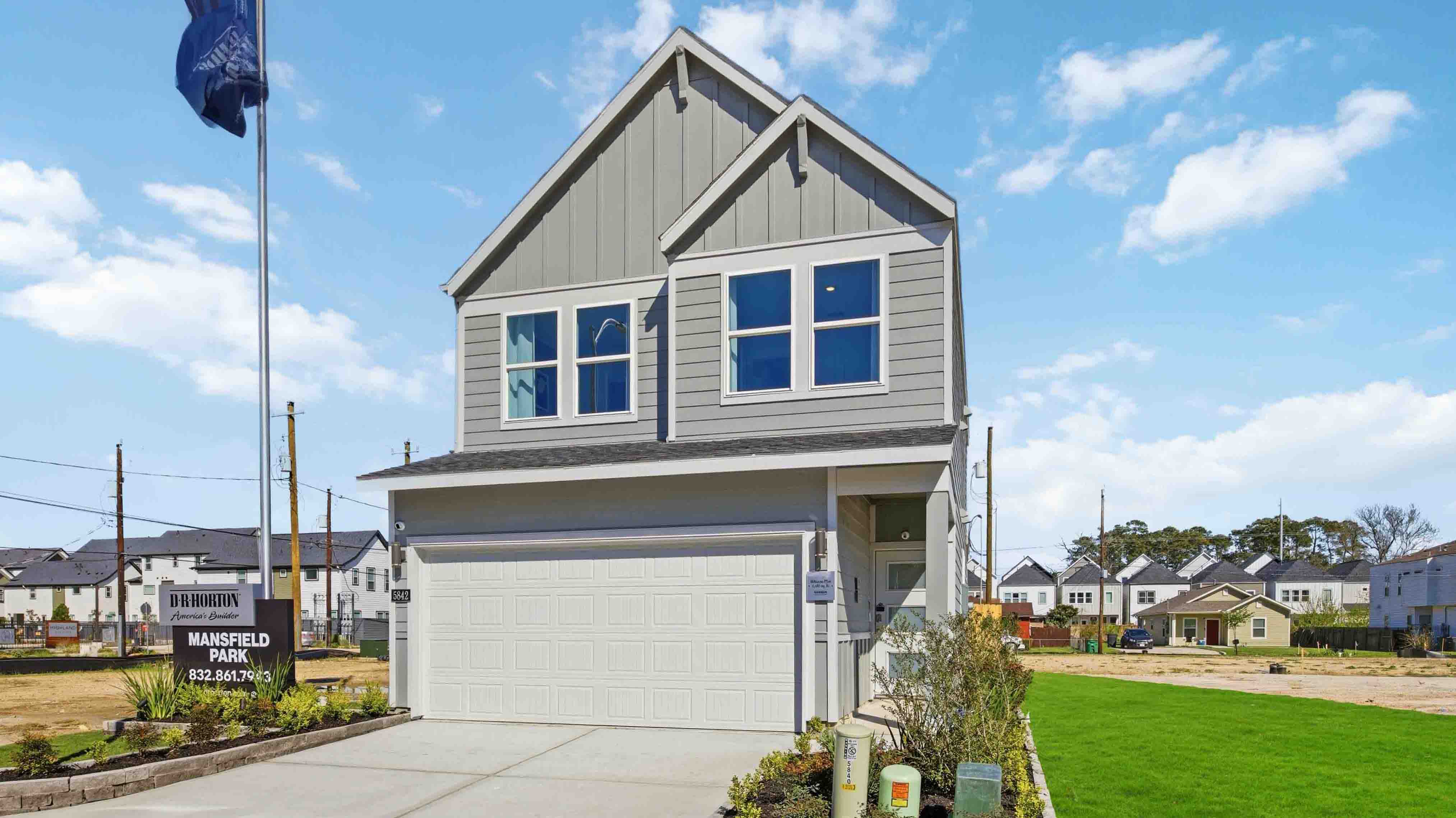 Modern two-story home with a siding exterior, two-car garage, and well-maintained front lawn in a urban neighborhood.