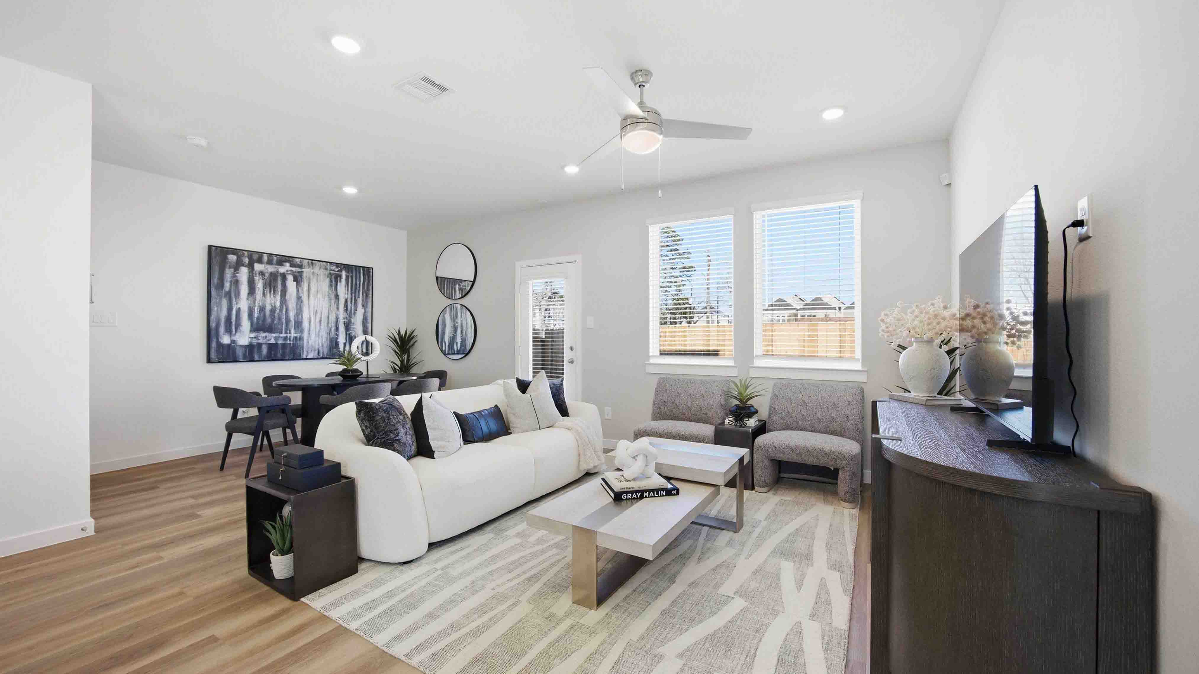 spacious living room with plenty of natural light from windows overlooking the backyard