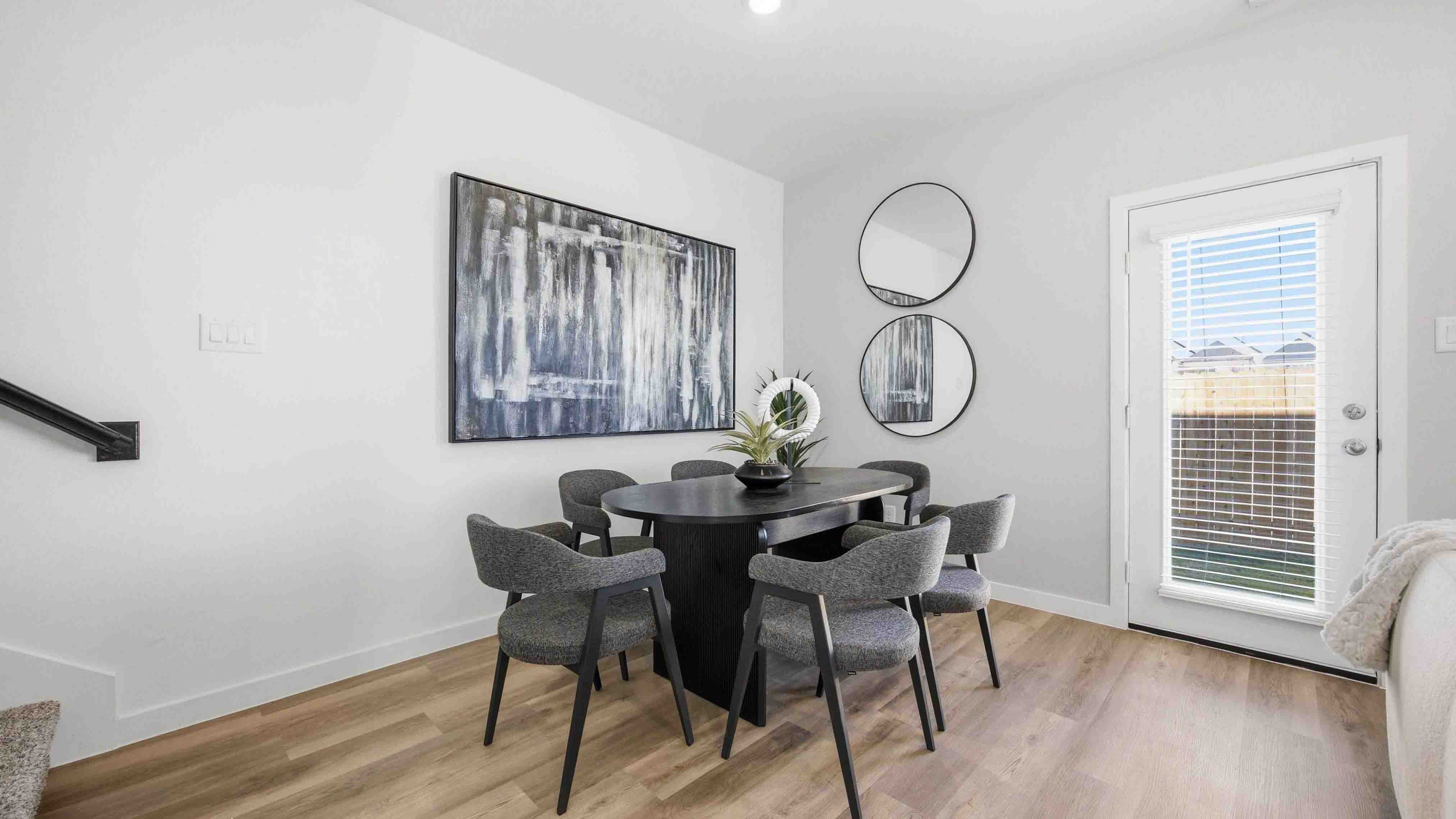 dining area with natural lighting that overlooks the backyard