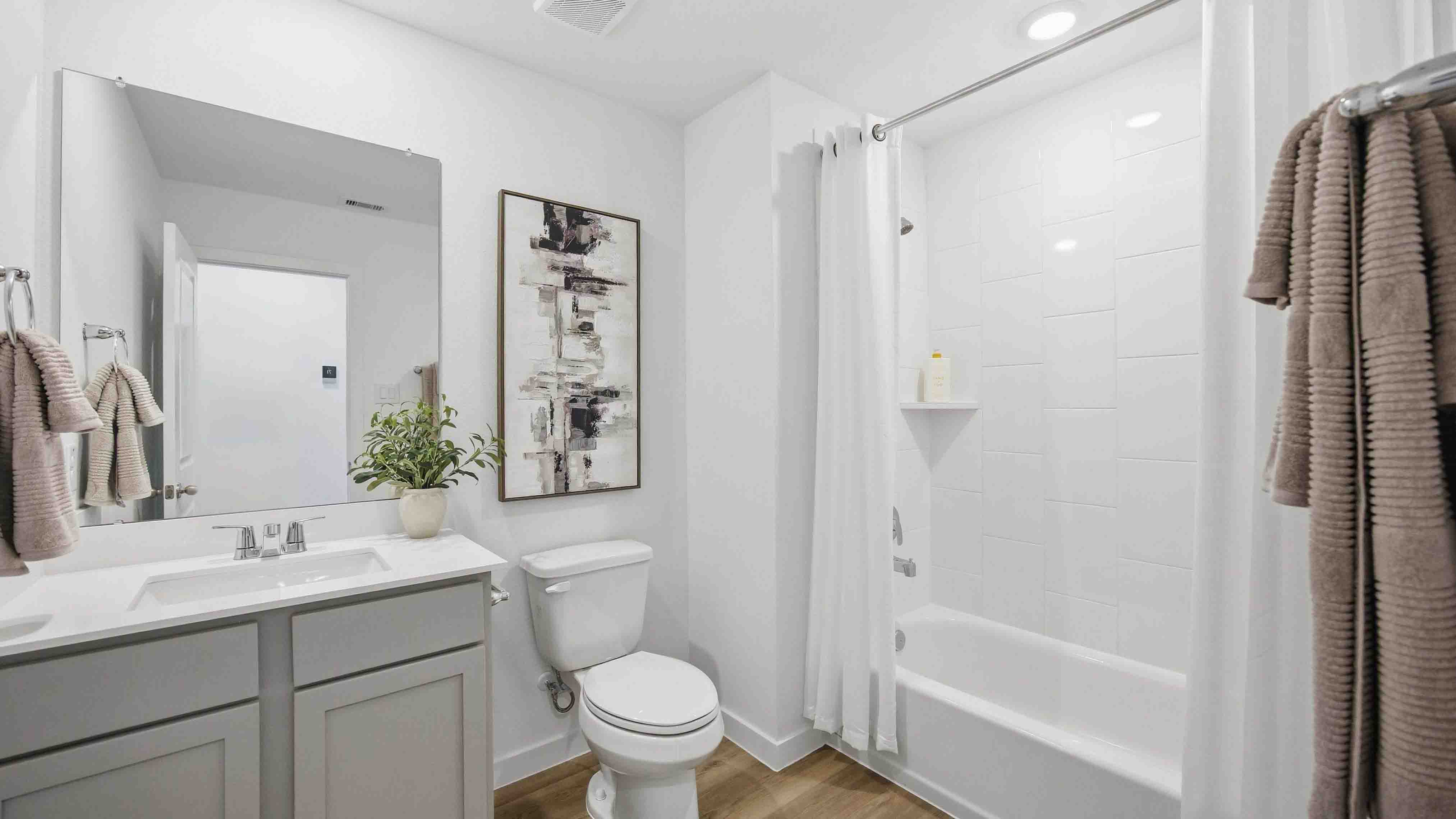 a spacious secondary bathroom with one sink vanity and standing tub