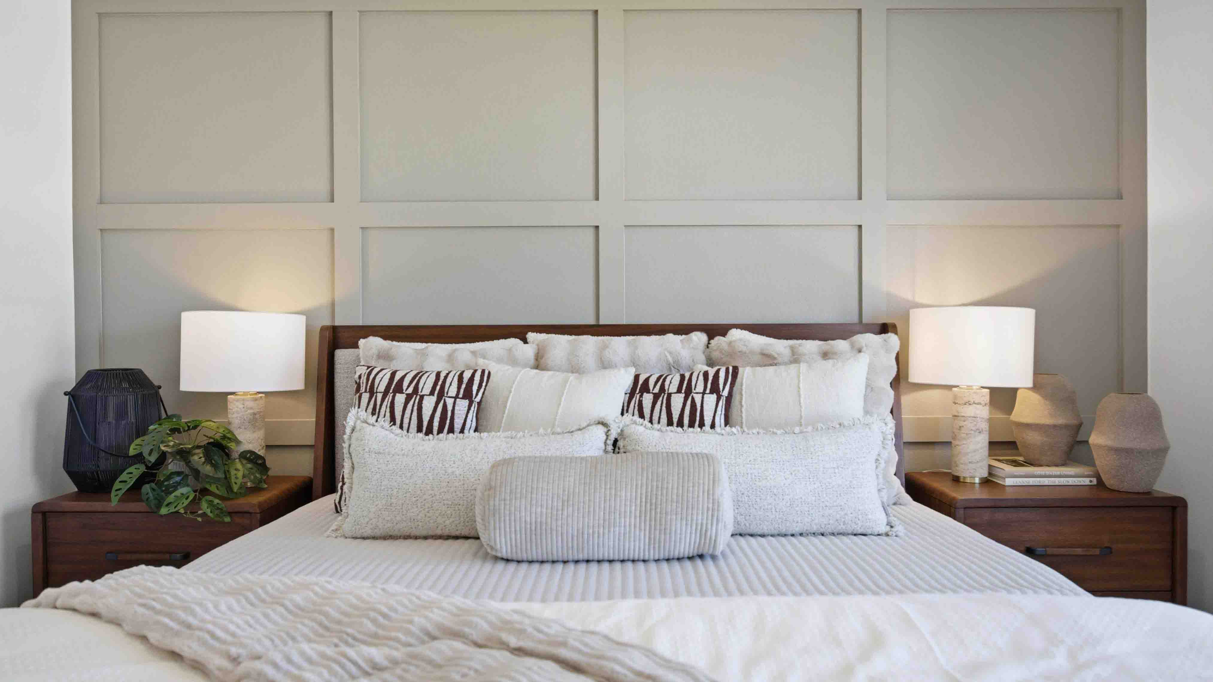a spacious primary suite with large windows for natural lighting