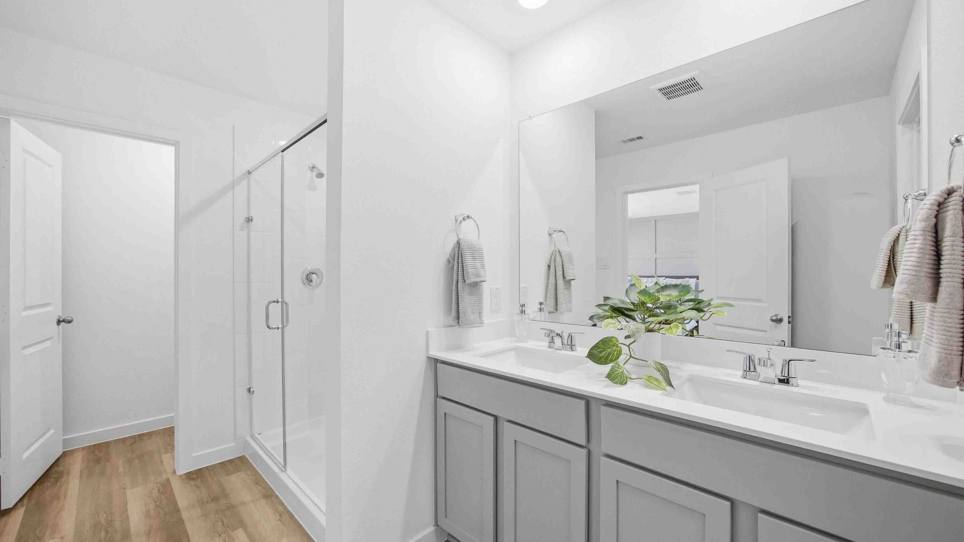 the en-suite primary bathroom has a double vanity and spacious walk-in closet
