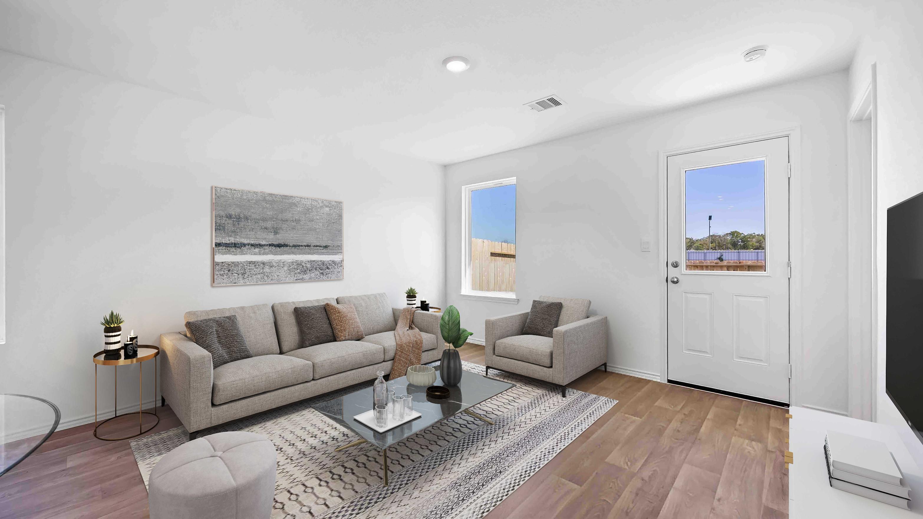 A well-organized living room that includes a kitchen and dining area, creating a warm and welcoming environment for gatherings.