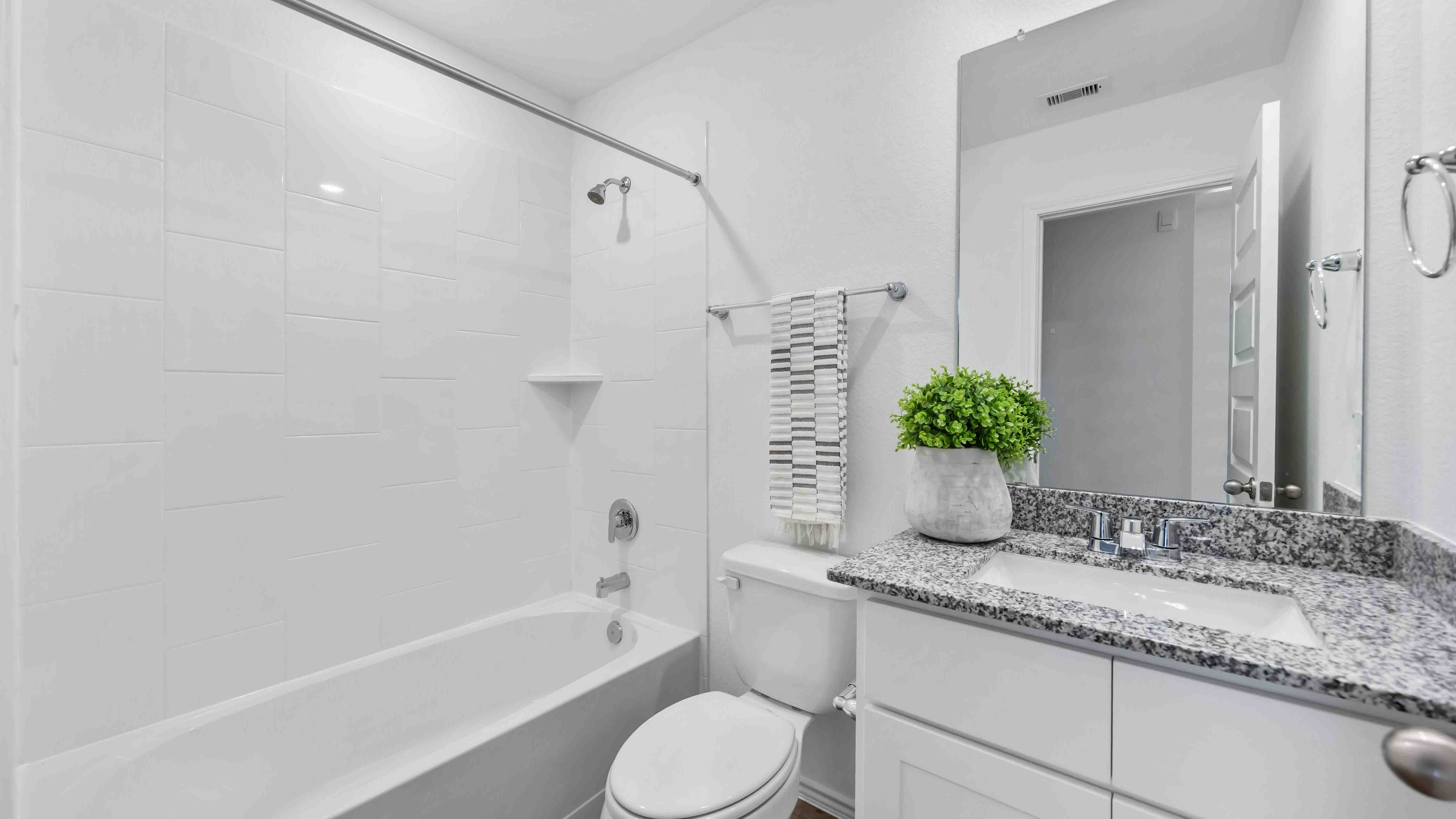 a spacious secondary bathroom with one sink vanity and standing tub