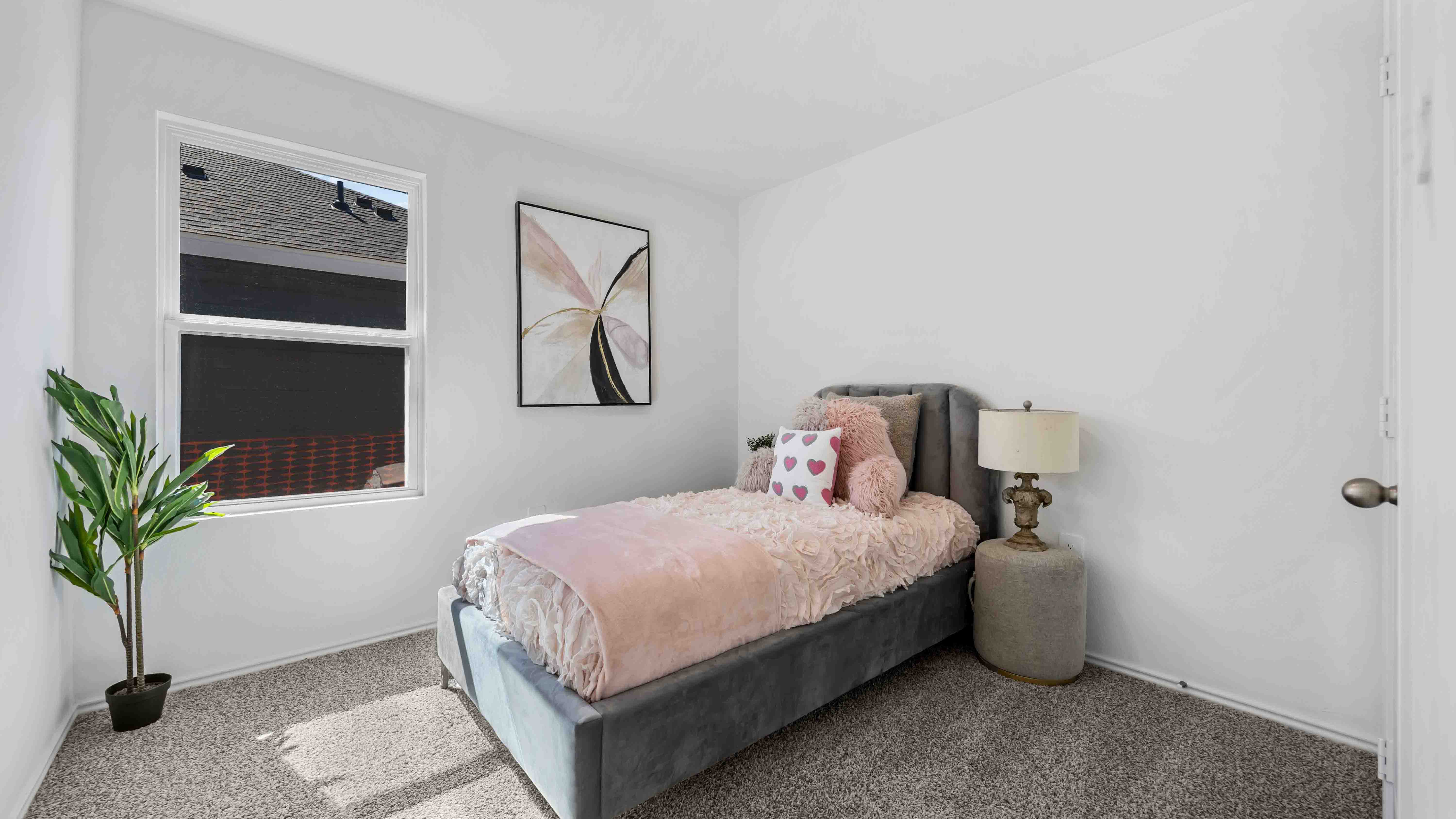 secondary bedrooms have light neutral walls and carpet flooring