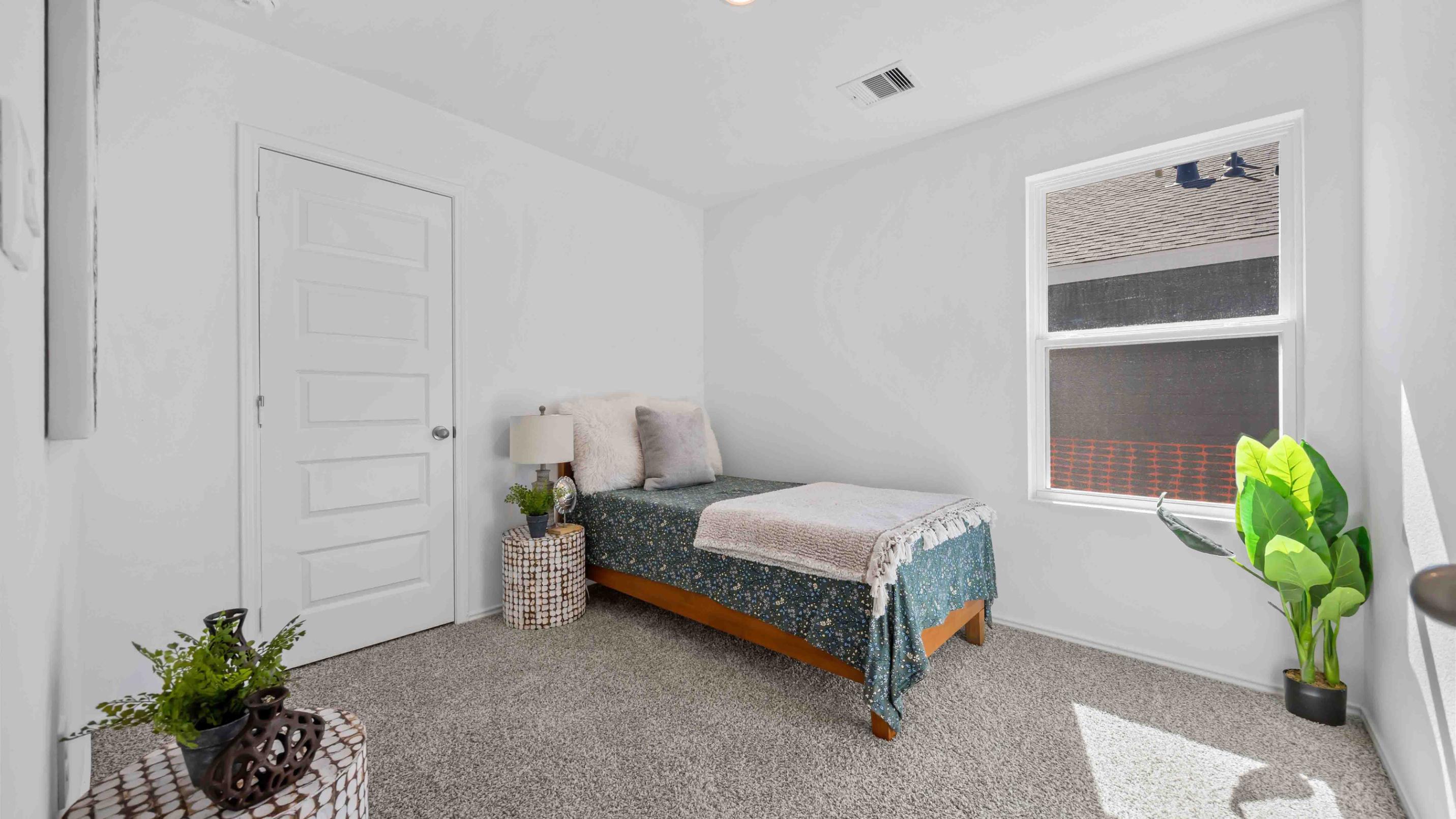 third bedroom has light neutral walls and carpet flooring