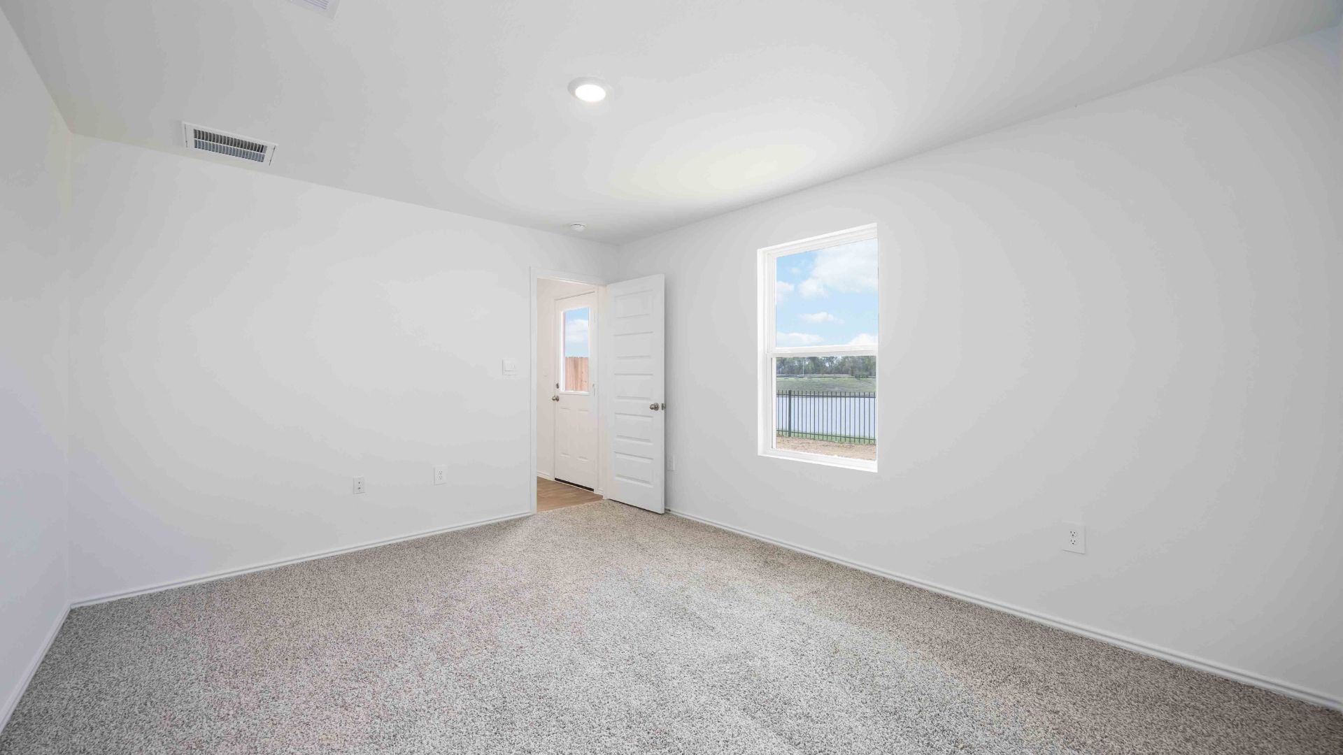 secondary bedrooms have light neutral walls and carpet flooring