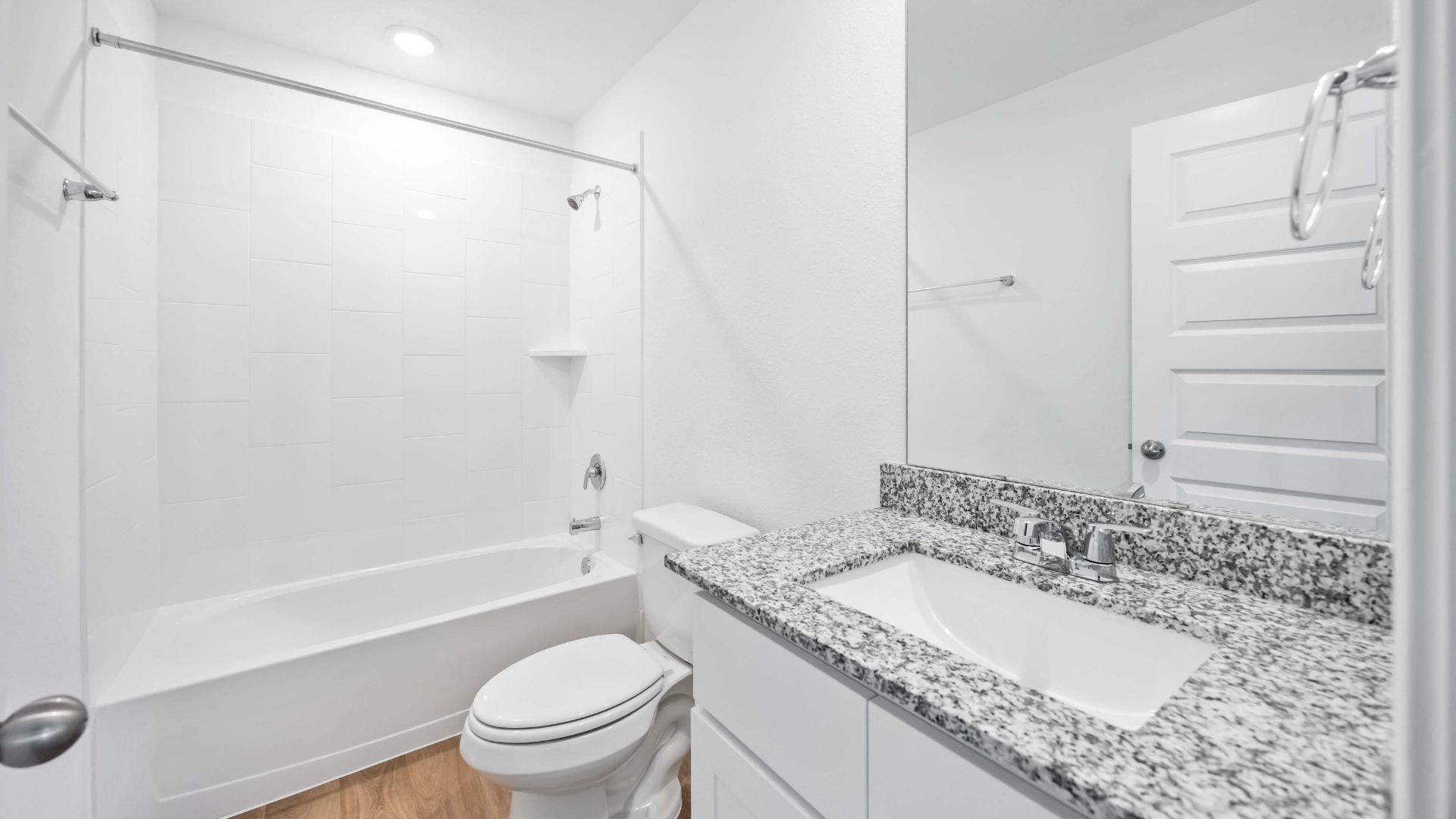 a spacious secondary bathroom with one sink vanity and standing tub