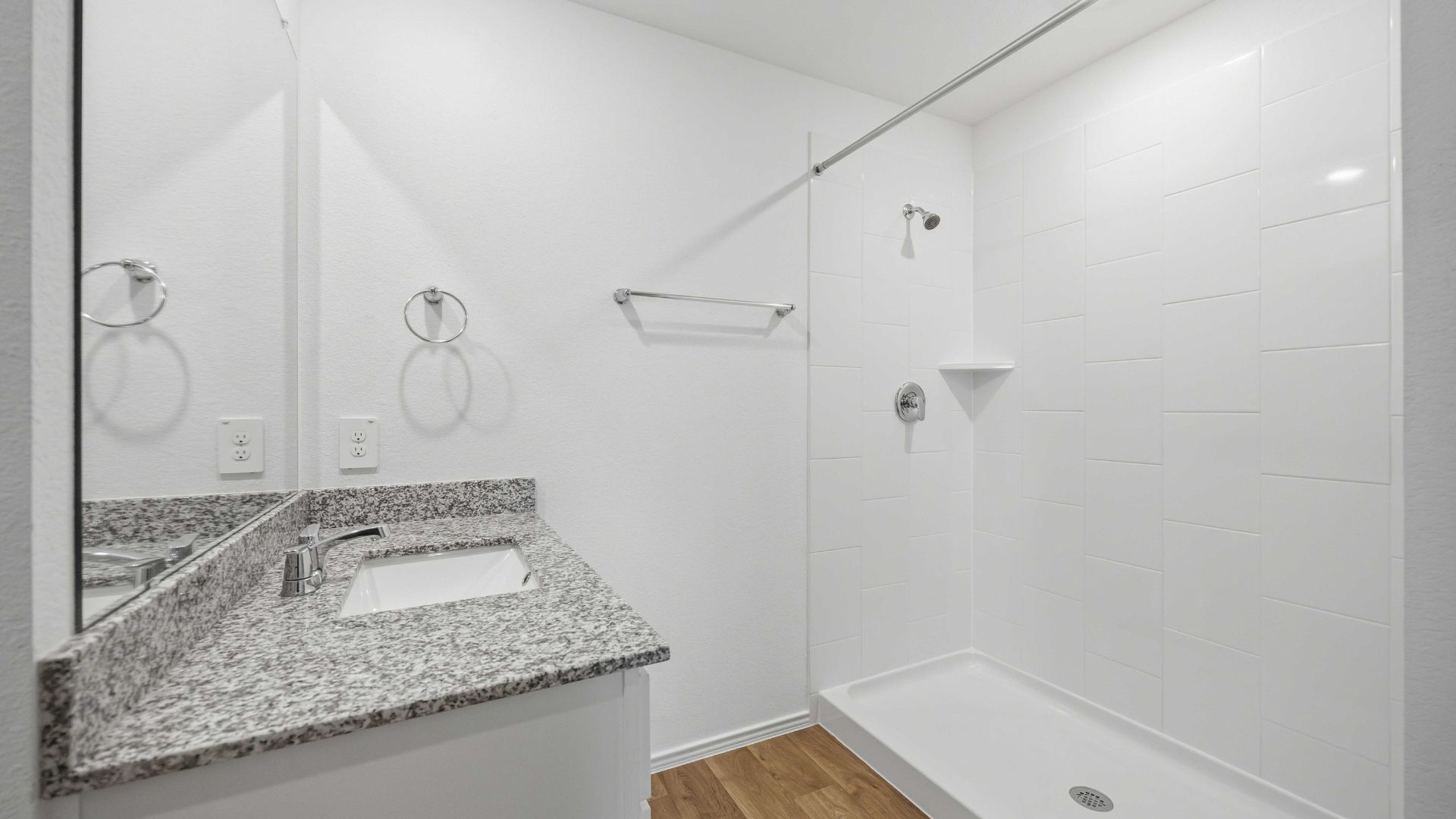 the en-suite primary bathroom has a single vanity and a standing shower