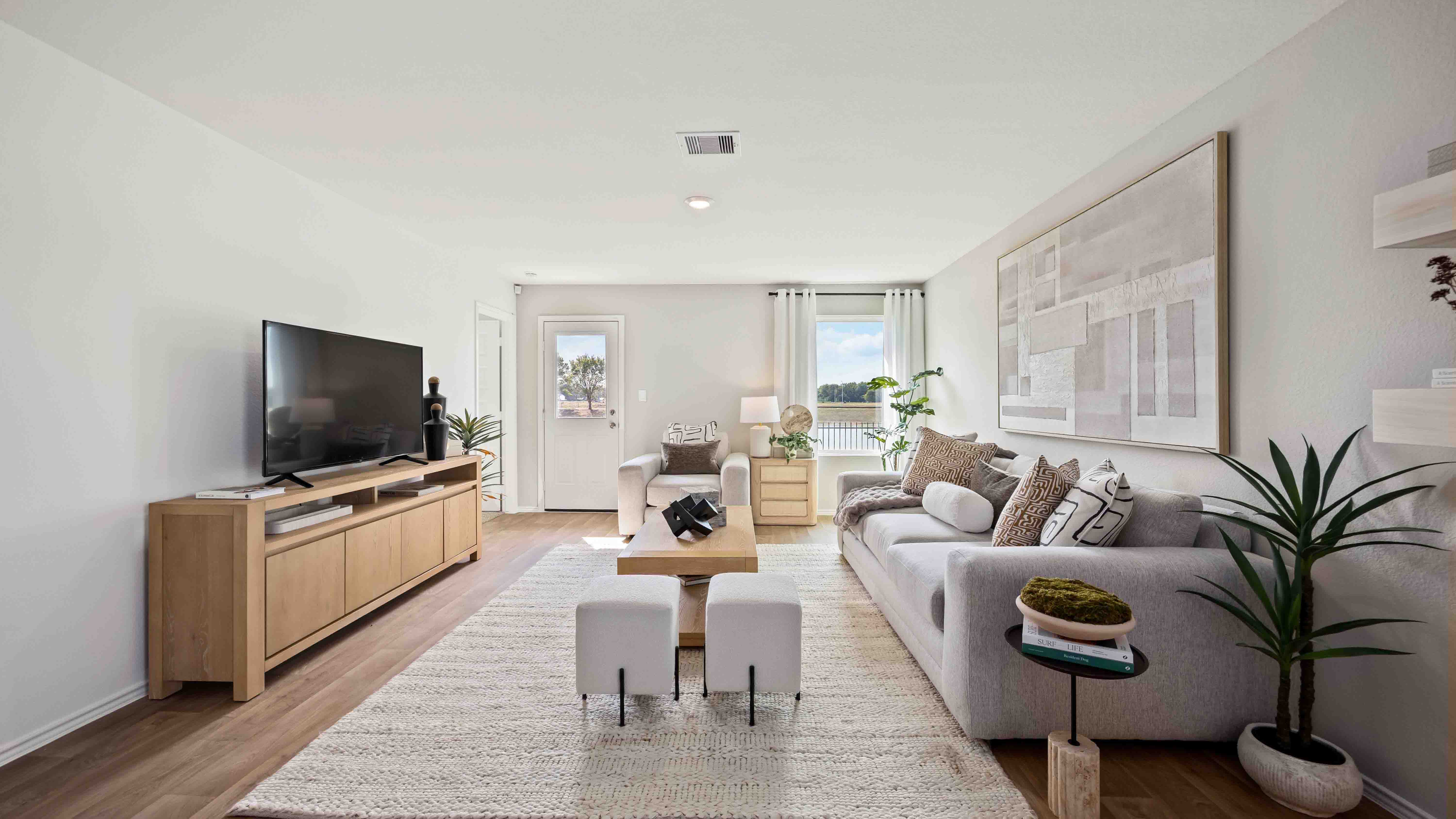 spacious living room with plenty of natural light from windows overlooking the backyard