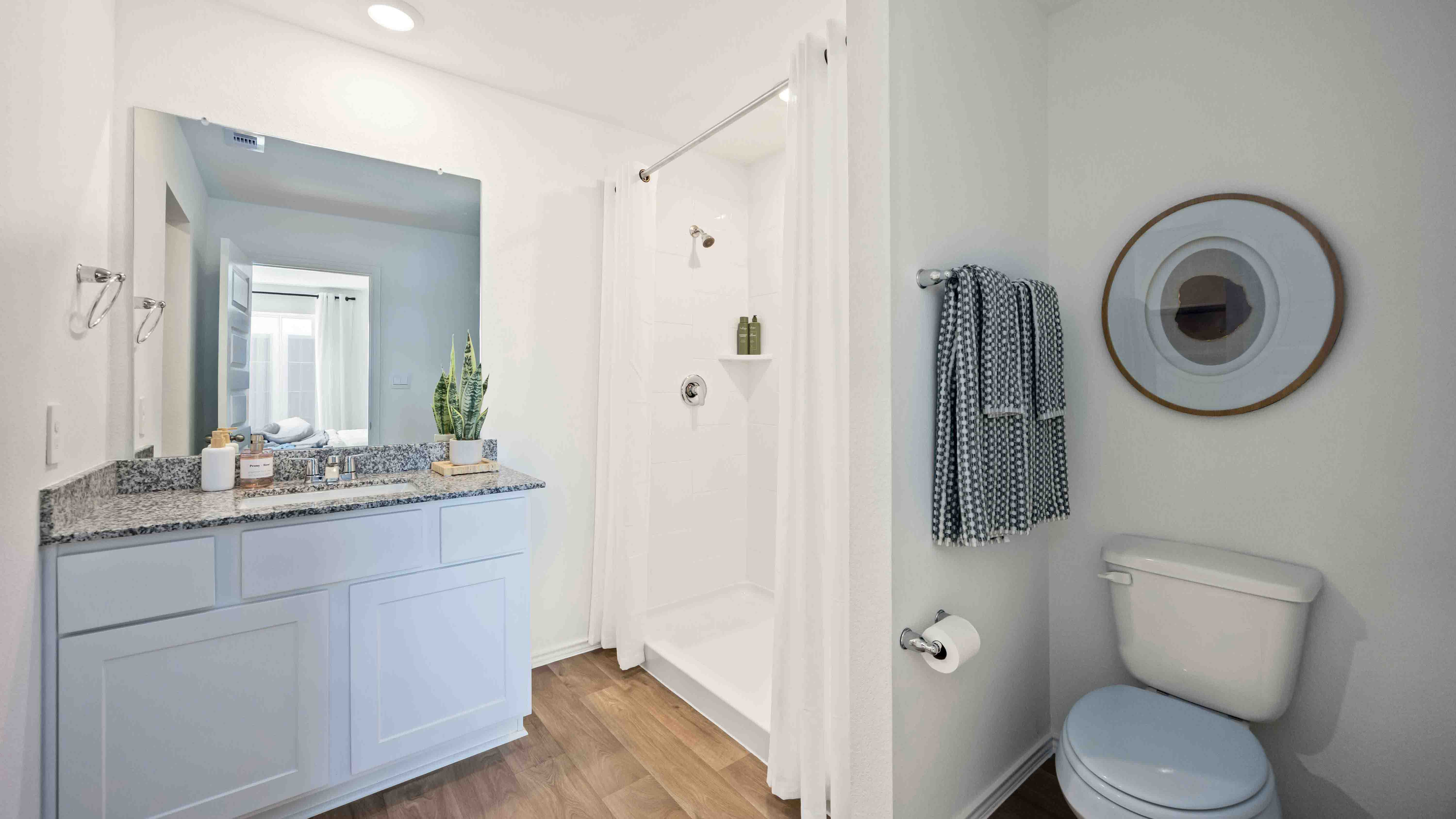 the en-suite primary bathroom has a single vanity and a standing shower