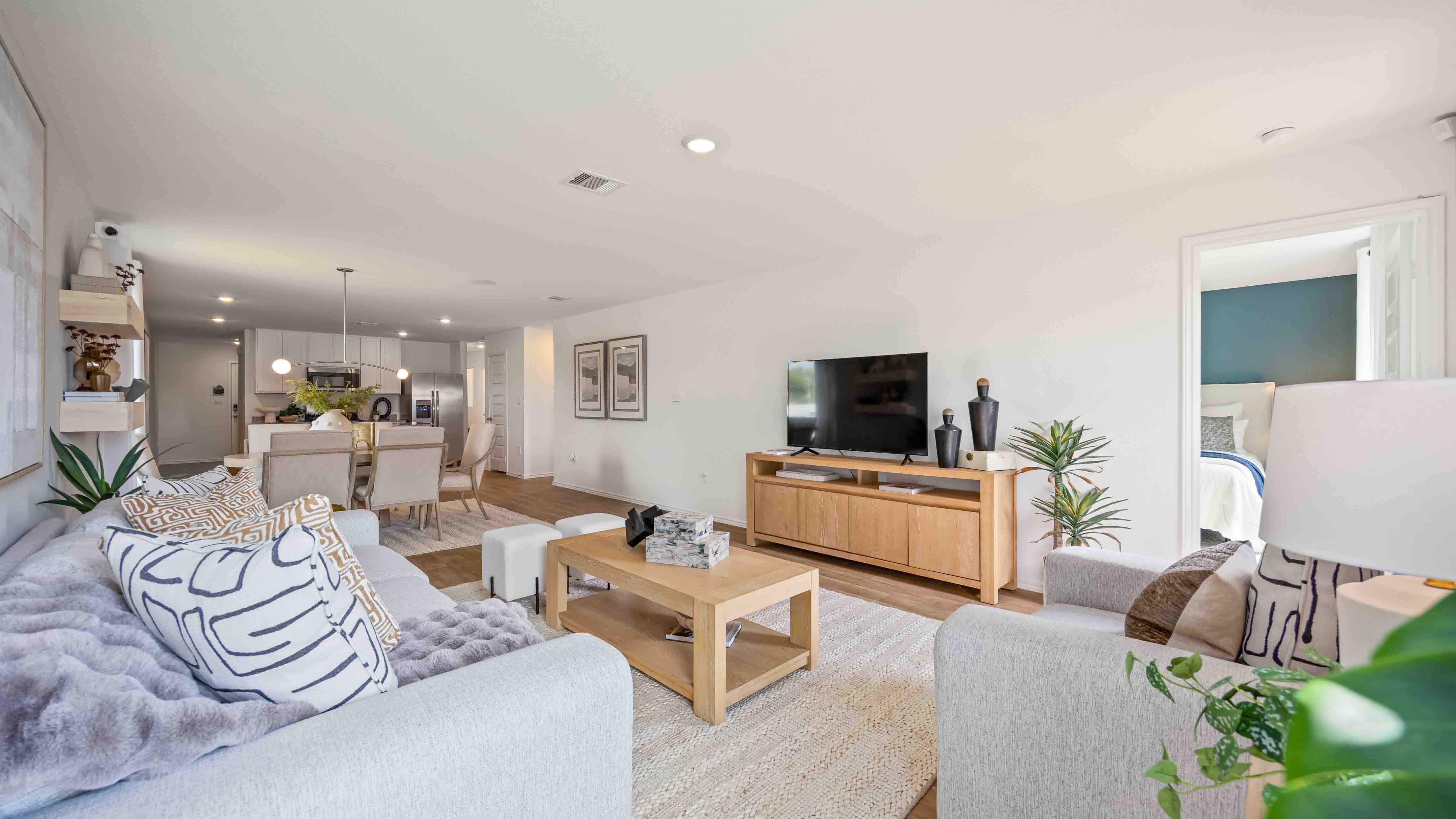 spacious living room with plenty of natural light from windows overlooking the backyard