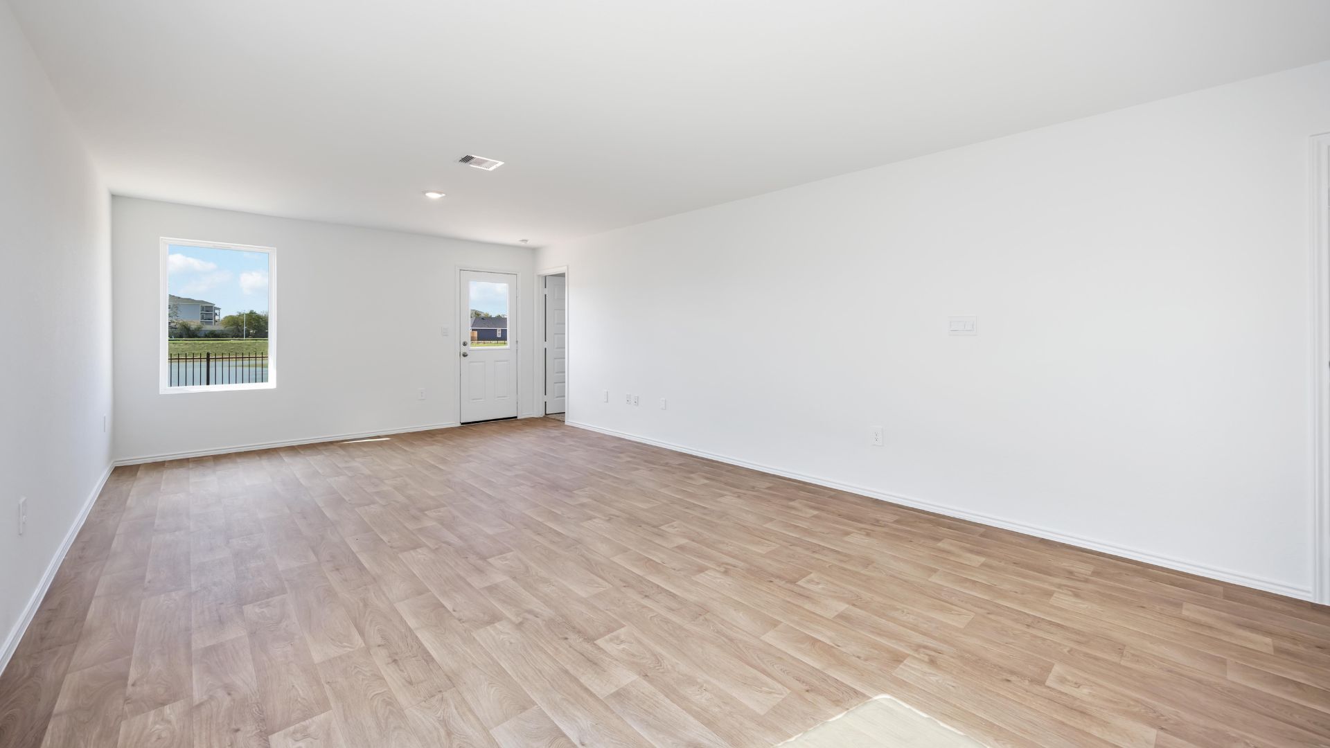 living room area with two large windows to the backyard