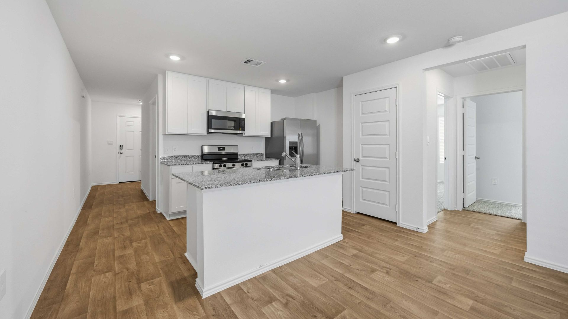 beautiful new kitchen with granite countertops and white cabinets