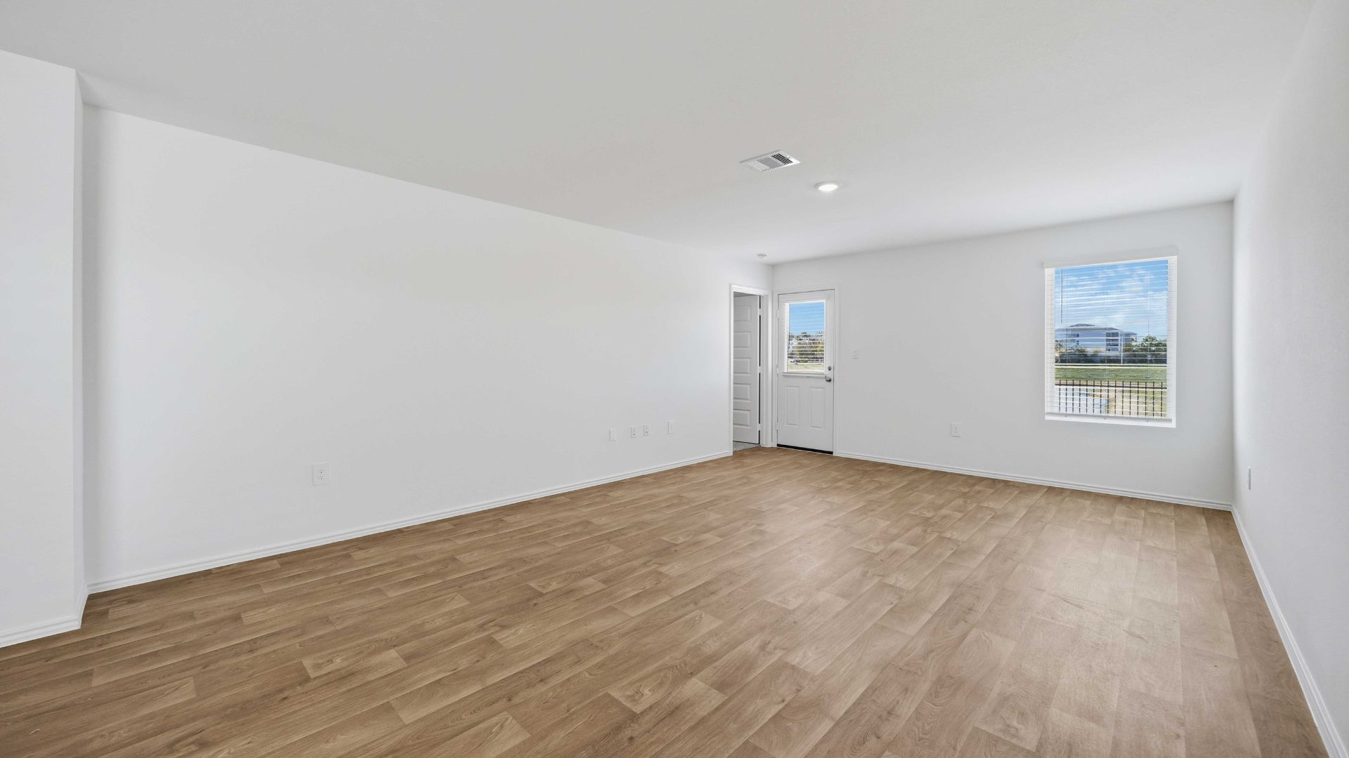 living room area with two large windows to the backyard