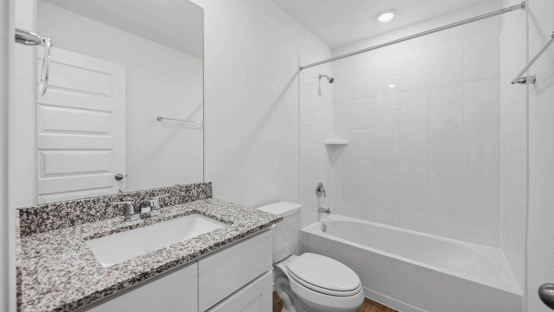 the en-suite primary bathroom has a single vanity and spacious walk-in closet