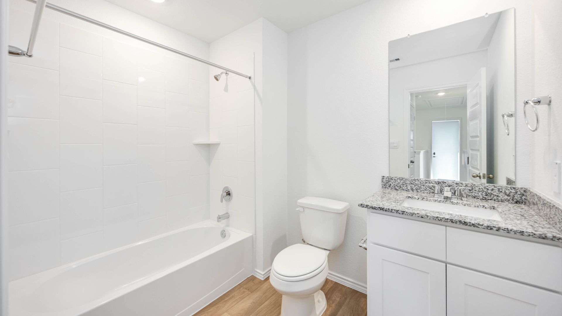 a spacious secondary bathroom with one sink vanity and standing tub