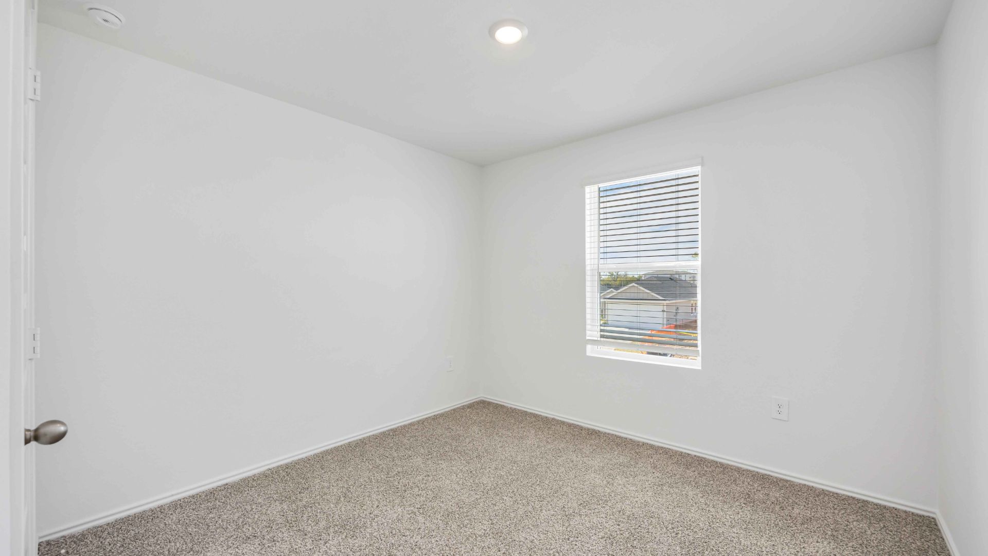 third bedroom has light neutral walls and carpet flooring