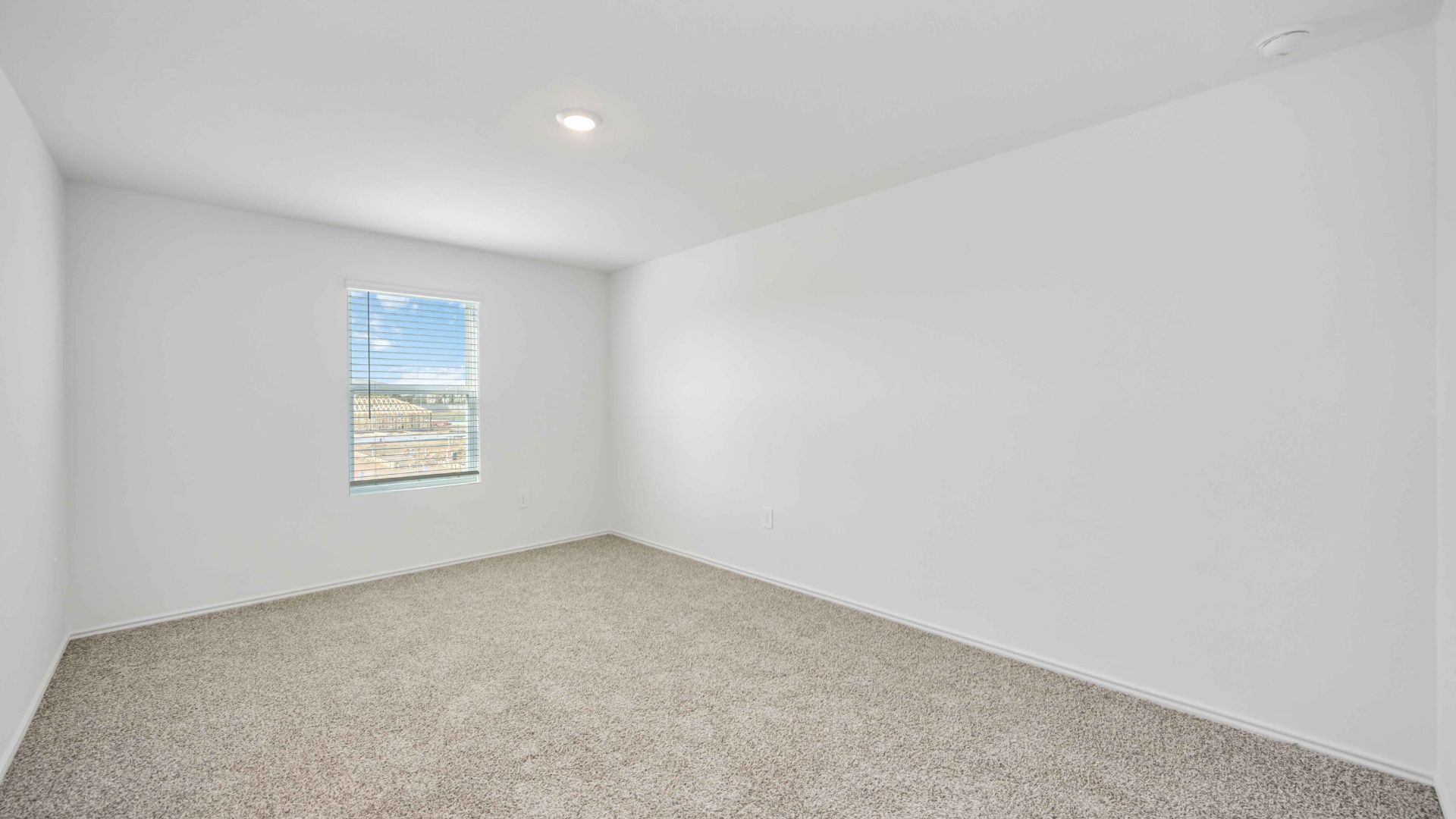 a spacious primary suite comfortably fits a king size bed and additional bedroom furniture
