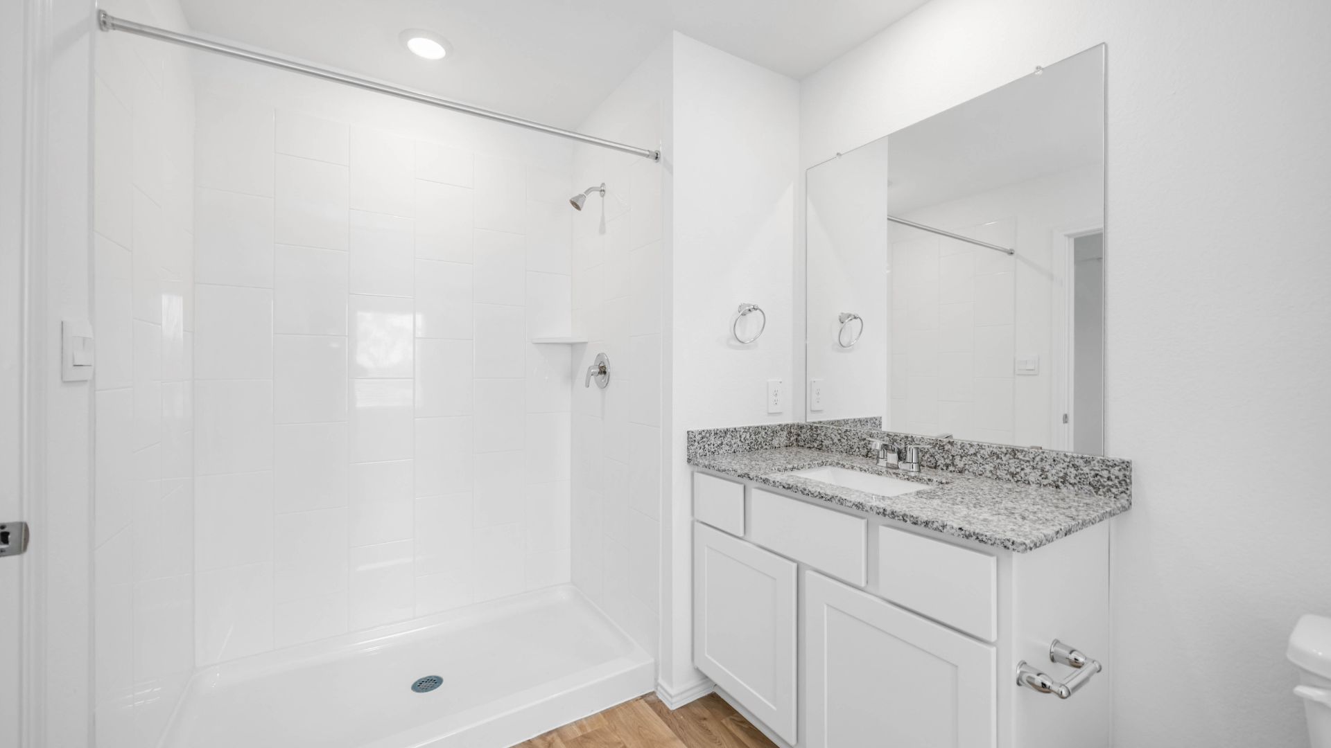 the en-suite primary bathroom has a single vanity and spacious walk-in closet
