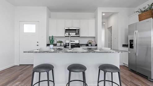 Kitchen with an island for additional seating and storage