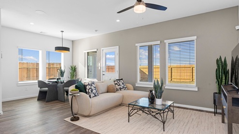 Living room area with windows leading to backyard