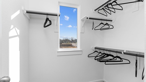 Primary walk-in closet with exterior window