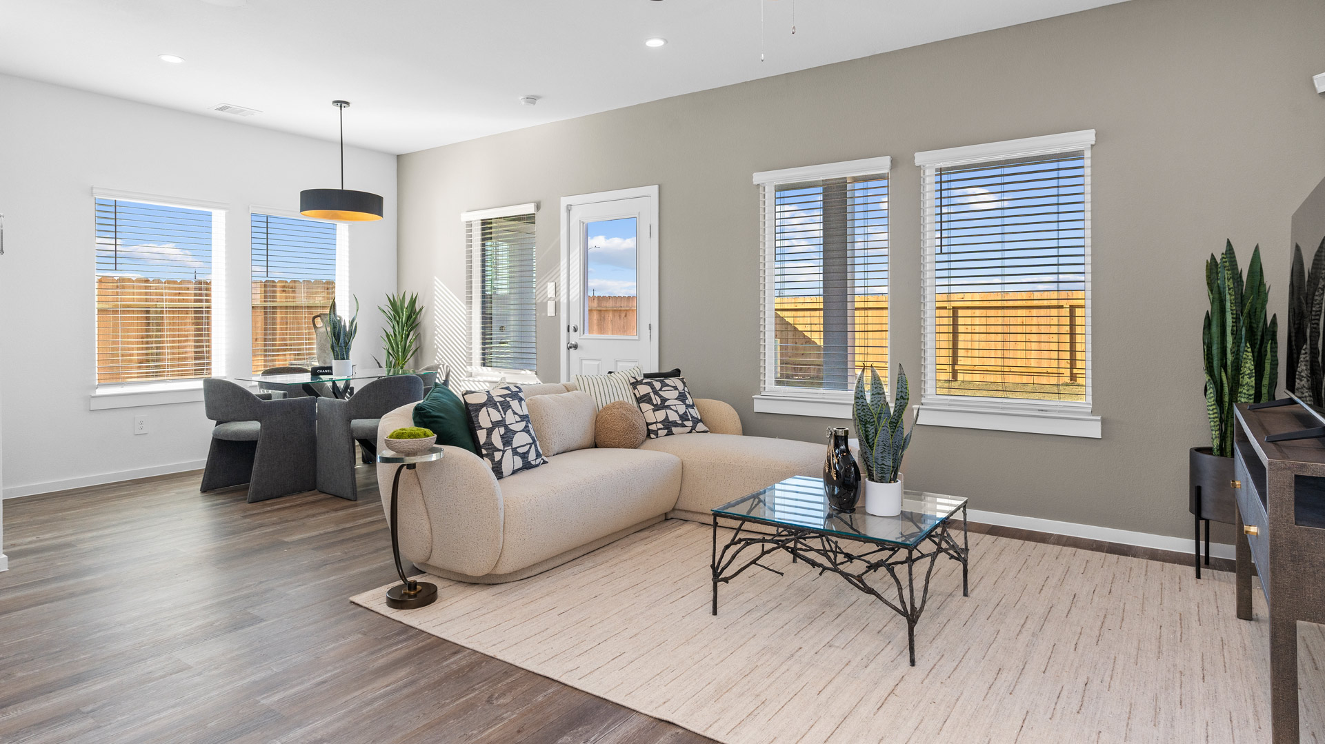 a spacious living room overlooks the backyard