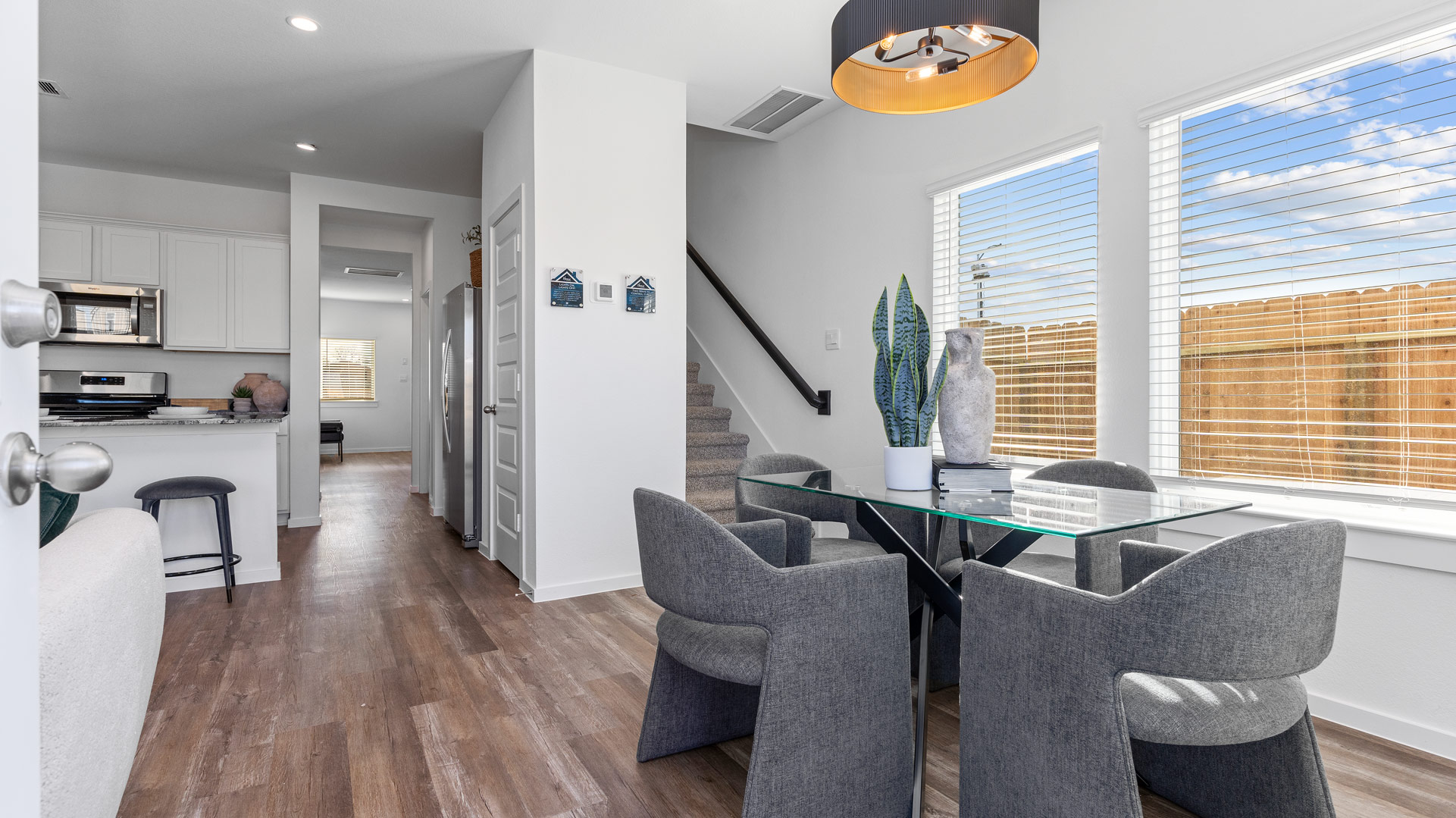 the dining area, also located at the rear of the home, opens to all main living spaces