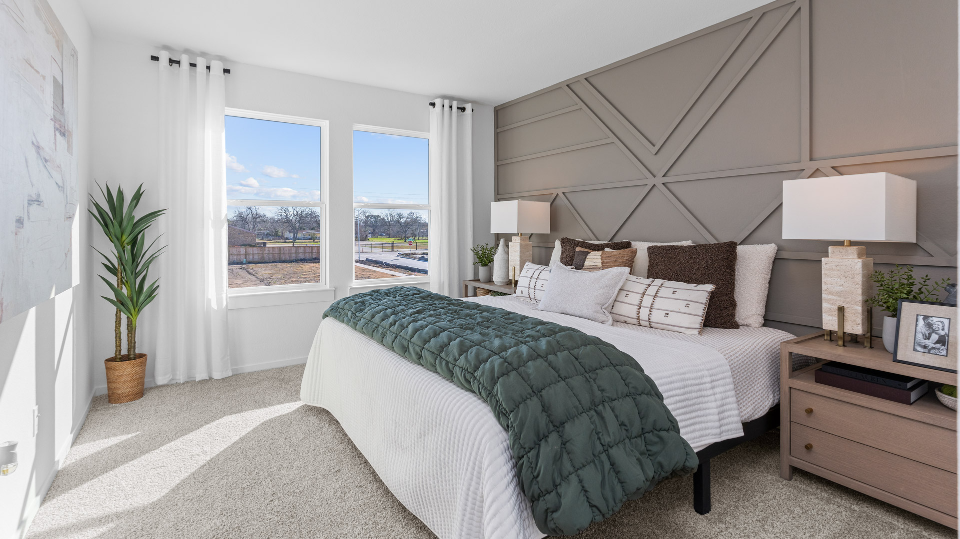 beautiful primary bedroom with two large windows for natural light