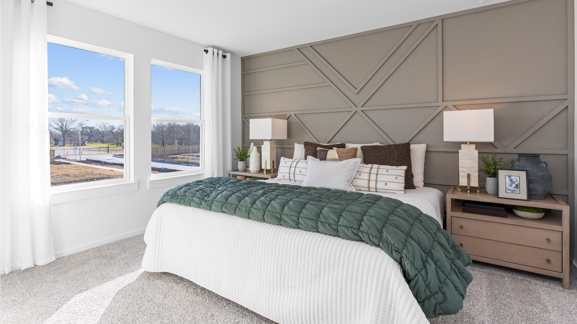 the spacious primary comfortably fits a king size bed and additional bedroom furniture