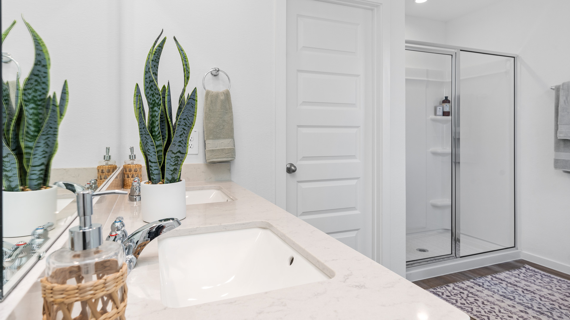 an en-suite primary bathroom features a double vanity and a walk-in shower