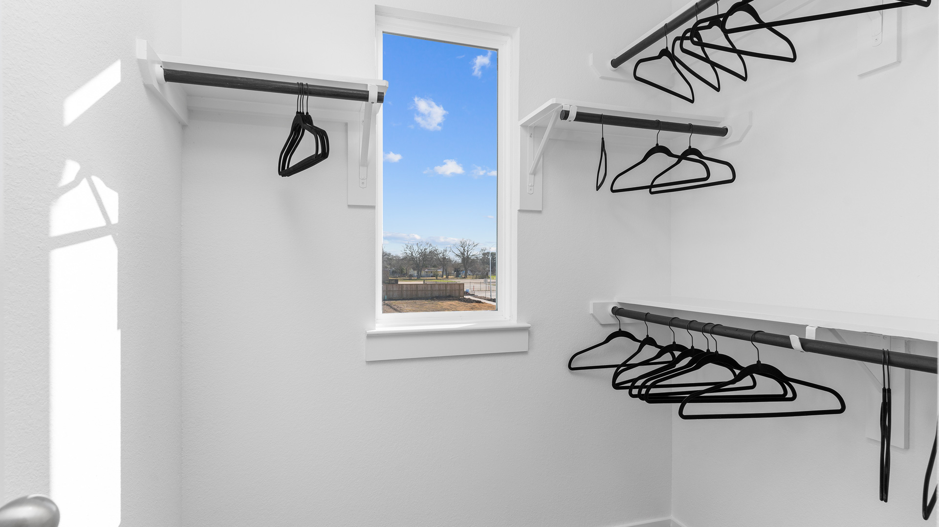 the spacious primary closet is located just off the bathroom for convenience