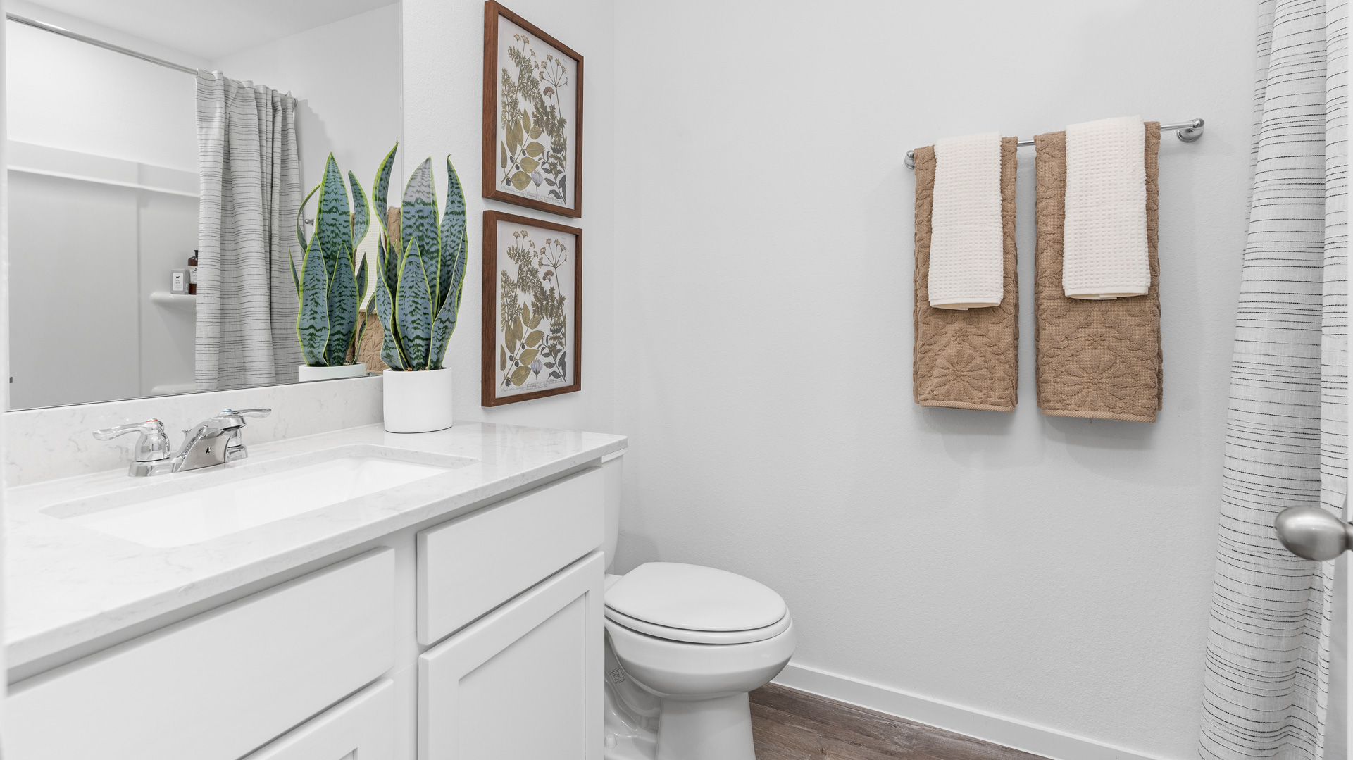 the second full bathroom upstairs has a single vanity and a shower/tub combo
