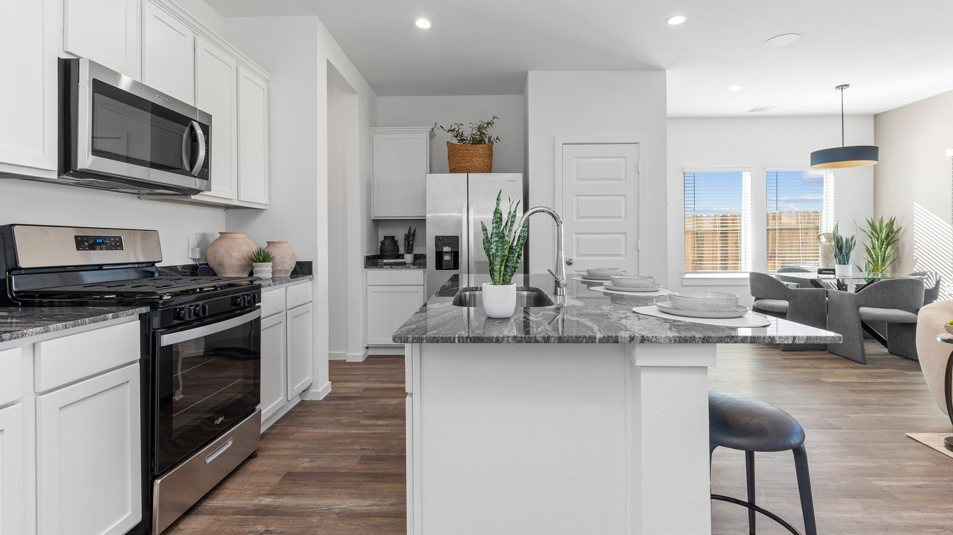 aspen plan kitchen with white cabinets and granite countertops