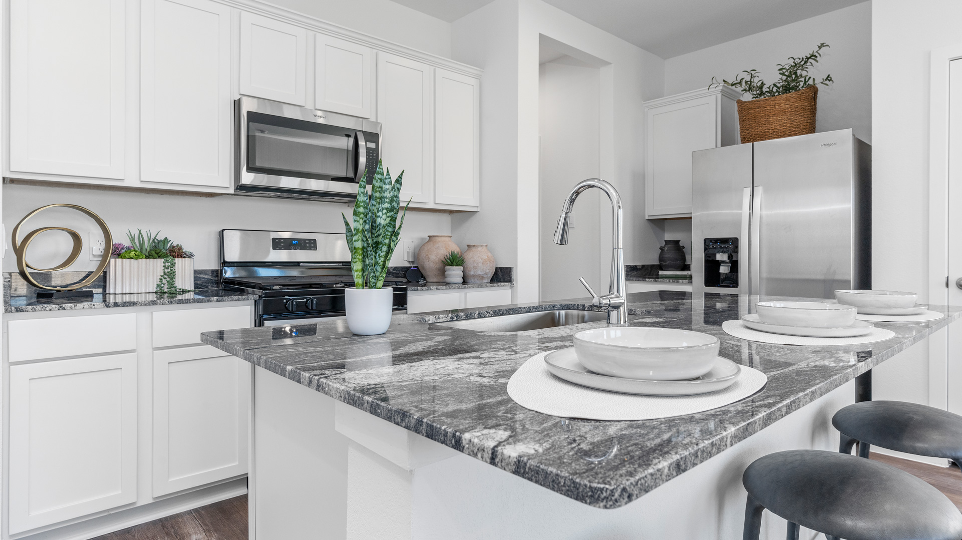 beautiful kitchen with white cabinets and granite counters