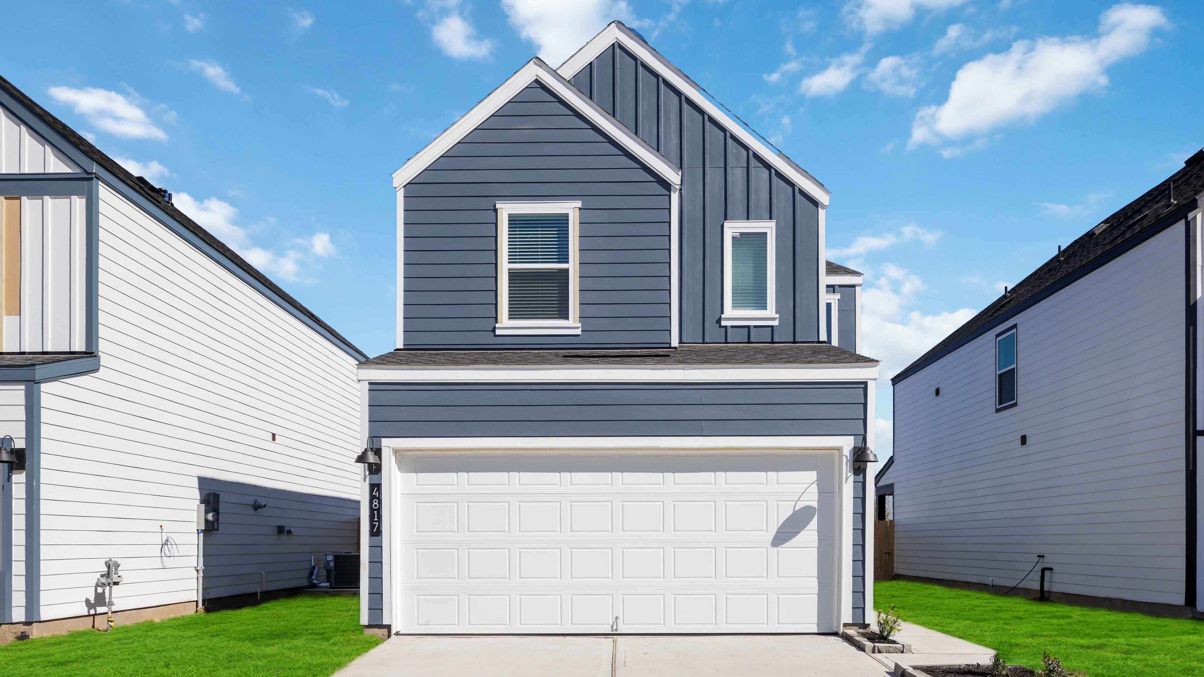 Two-story home with grey blue siding and a light trim