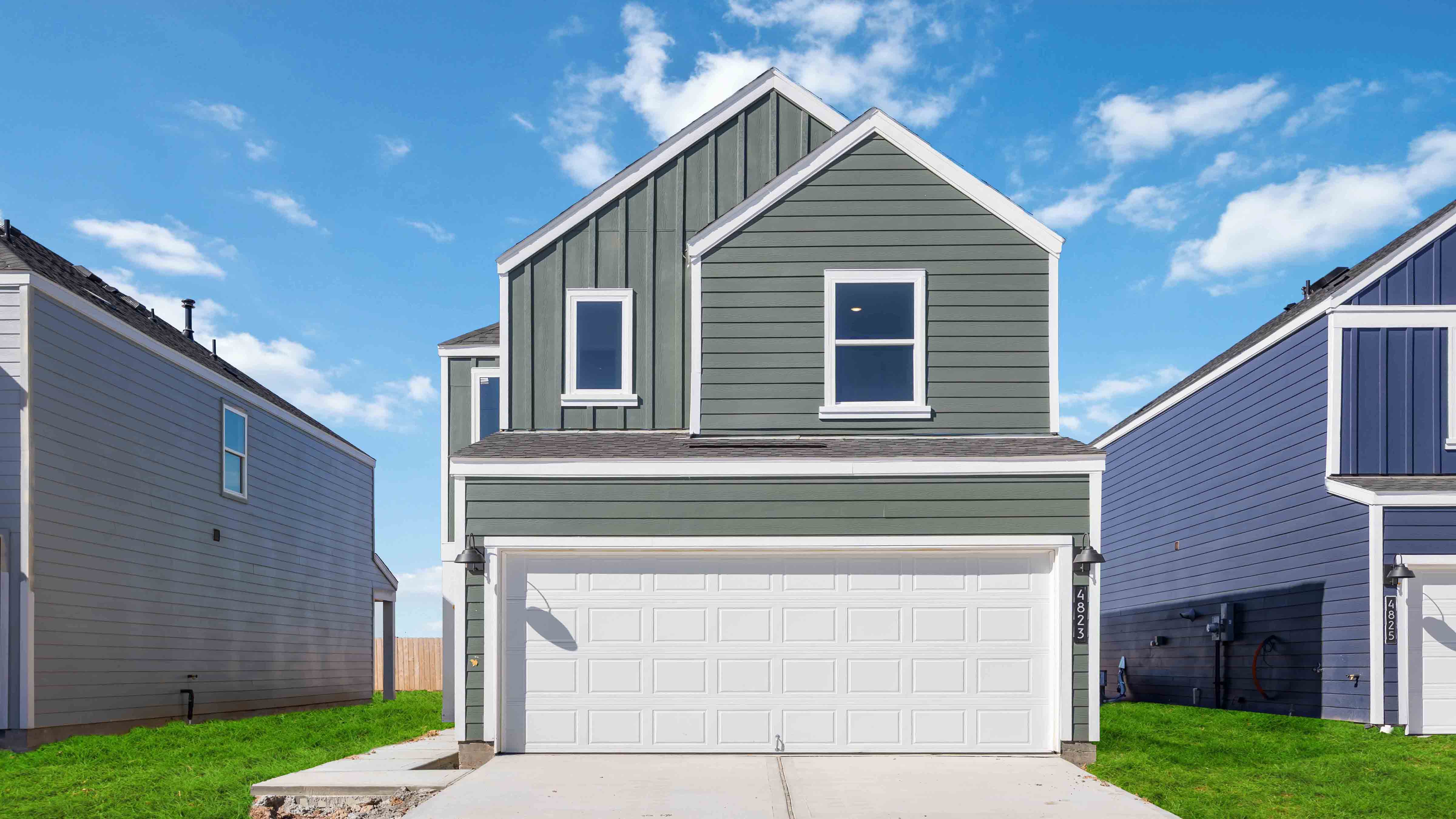 Two-story home with green siding and a white trim