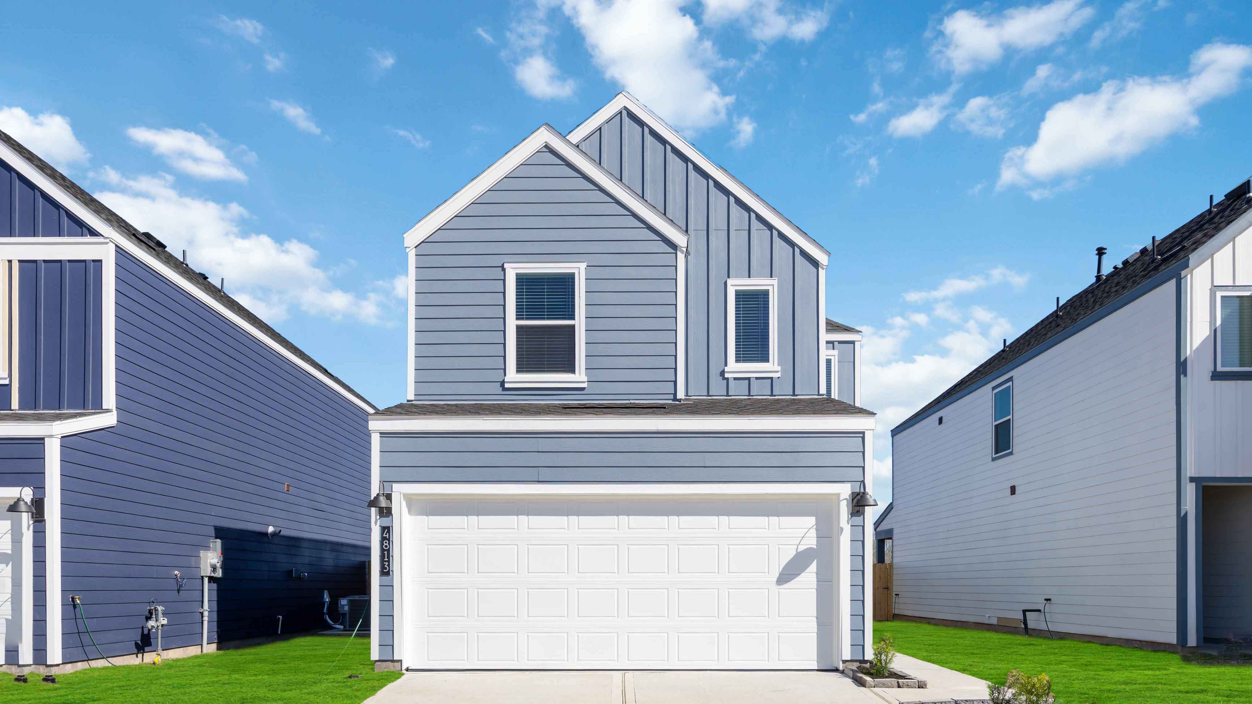 Two-story home with light grey siding and white trim