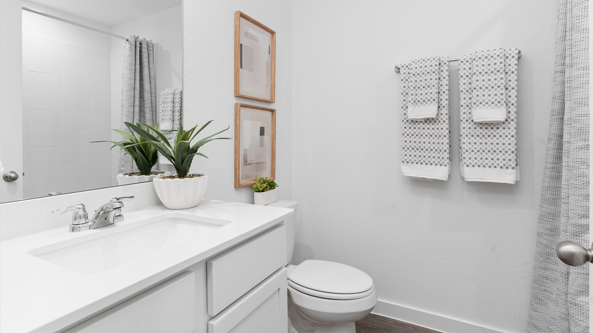 a second full bathroom is located upstairs with a single vanity and shower/tub combo