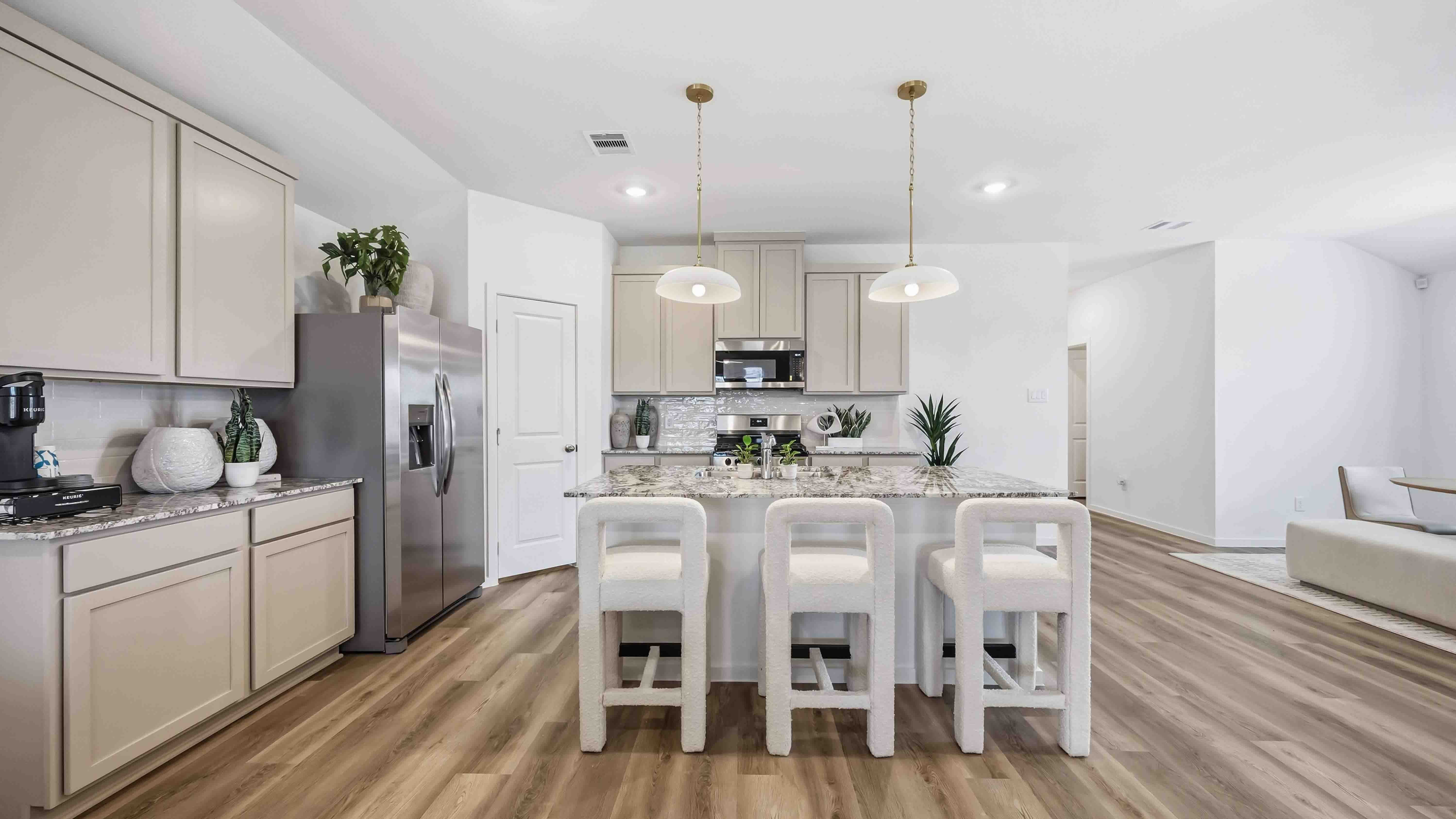 Contemporary kitchen adorned with light grey cabinets seamlessly integrated into an open dining area layout