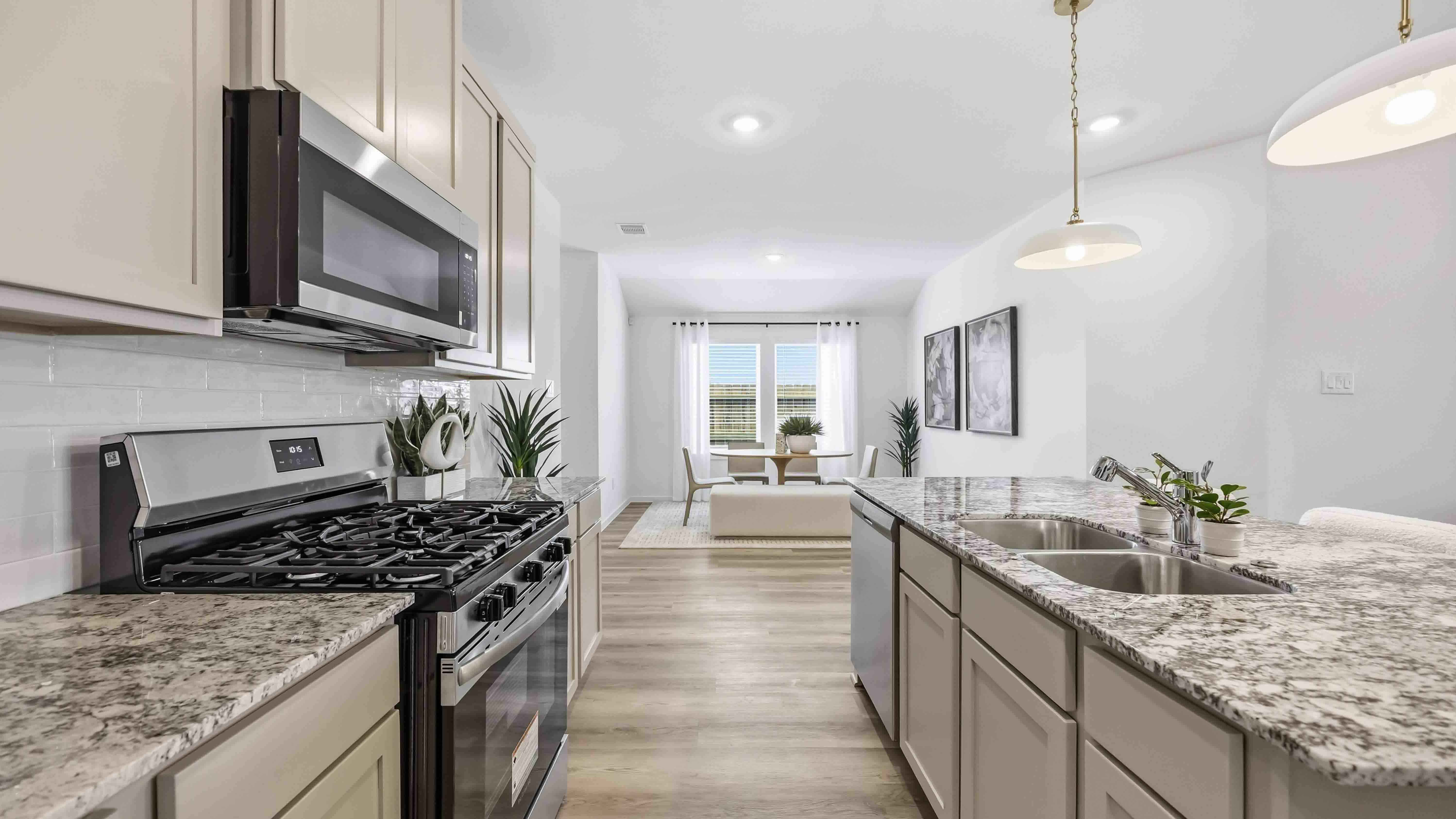 stainless steel appliances and light granite countertops