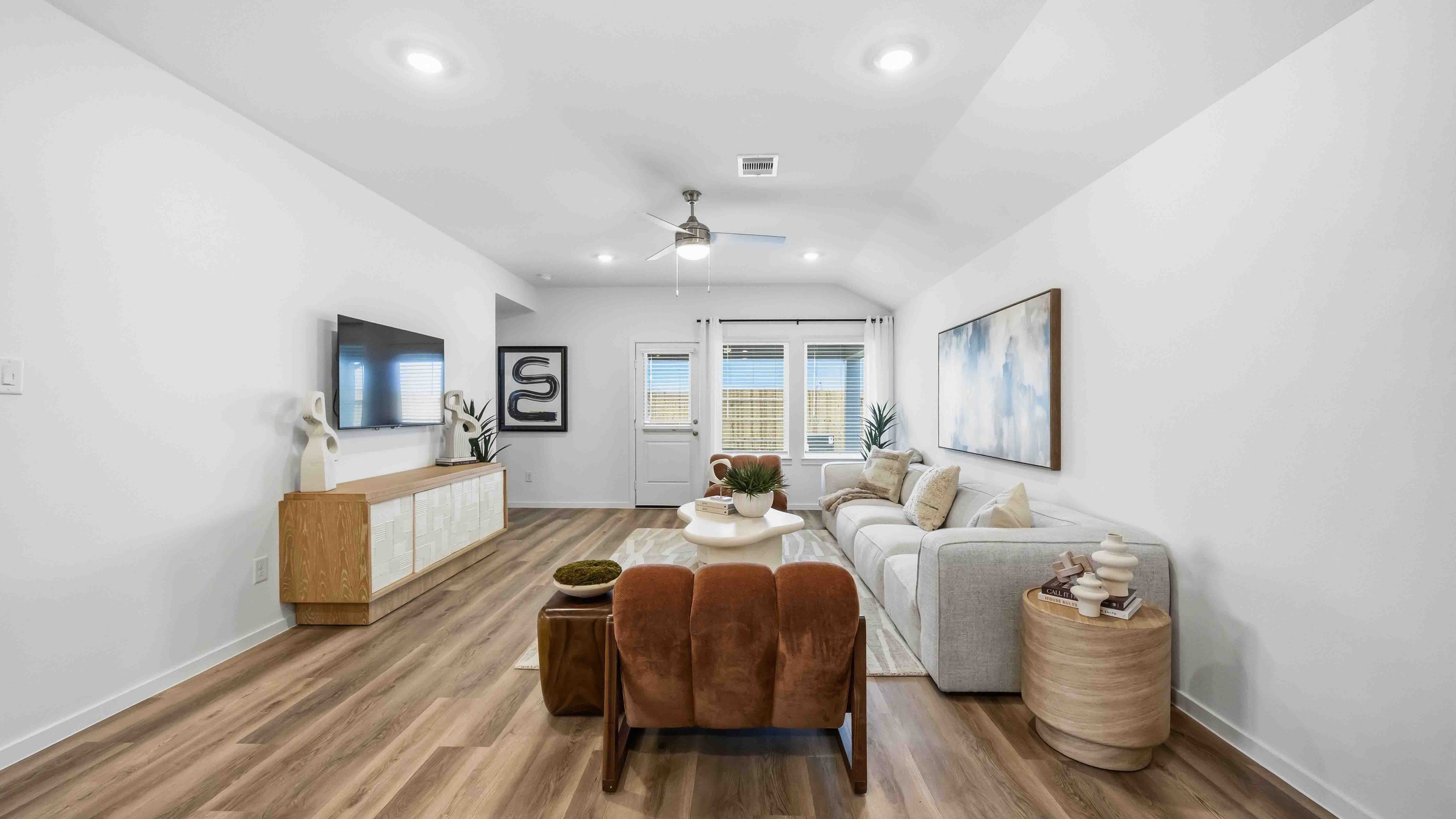 A well-organized living room that includes a kitchen and dining area, creating a warm and welcoming environment for gatherings