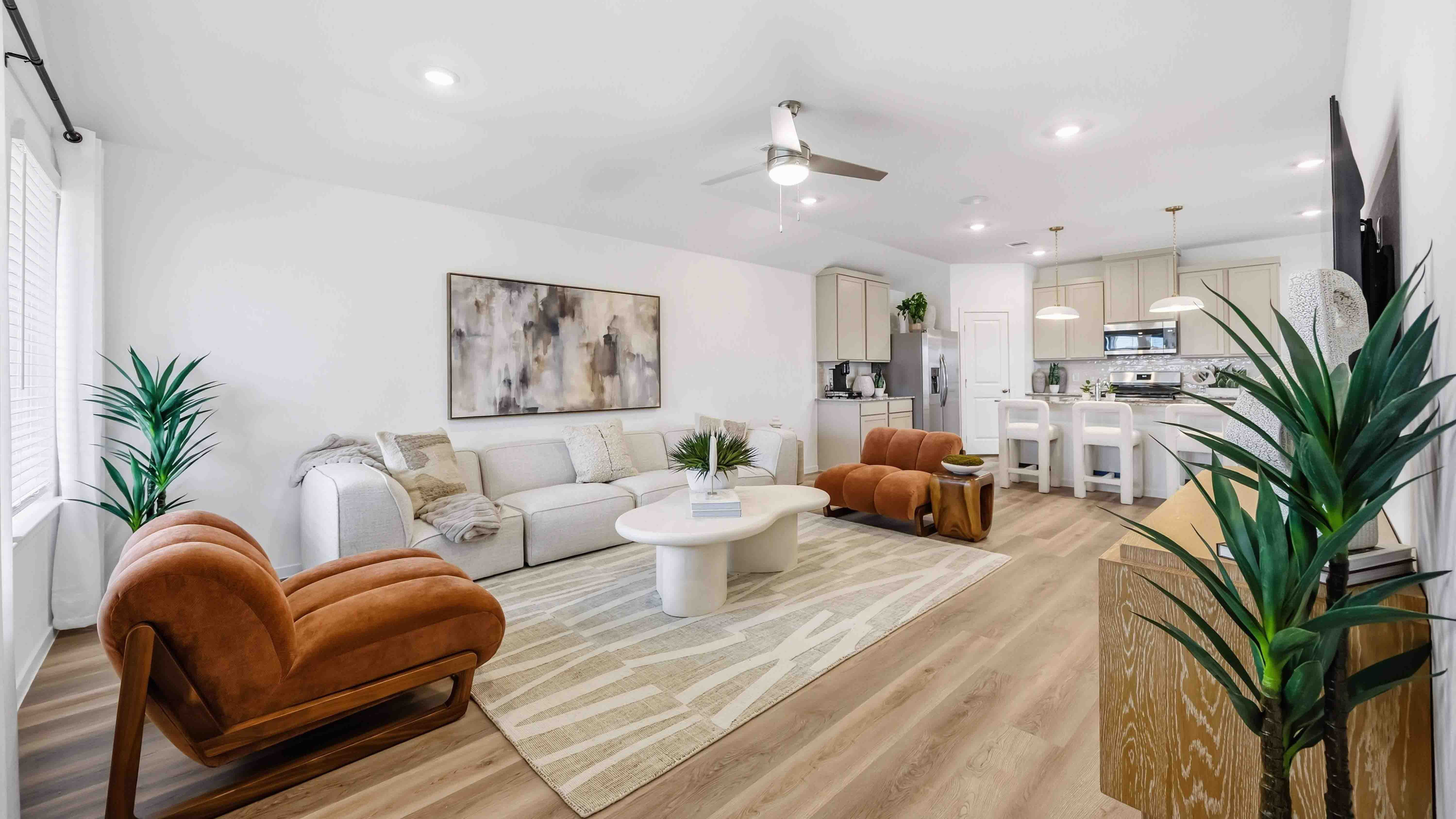 A cozy living room featuring a comfortable couch, a stylish coffee table, and an elegant painting on the wall