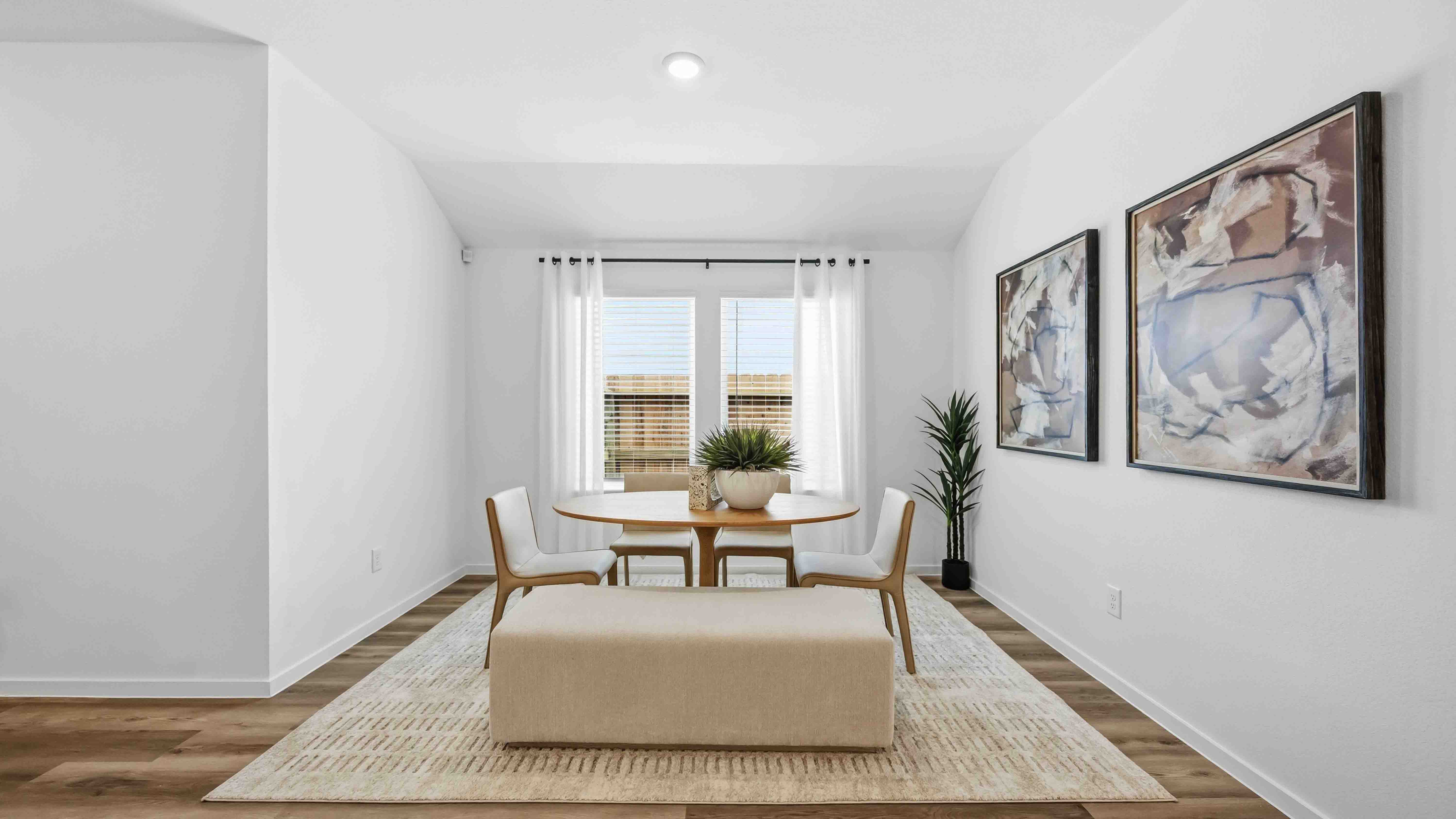 dining area with natural lighting that overlooks the backyard