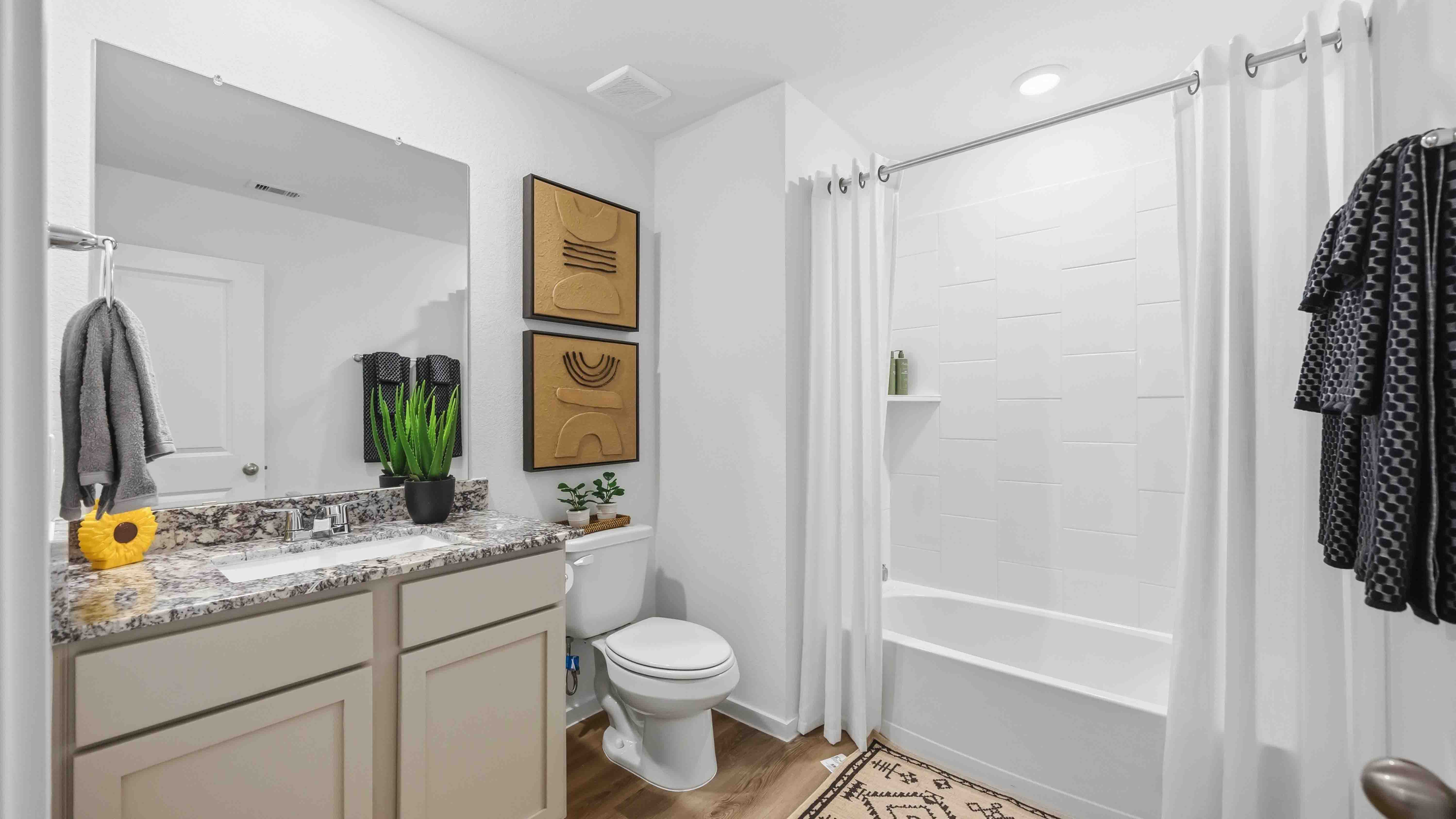a spacious secondary bathroom with one sink vanity and standing tub